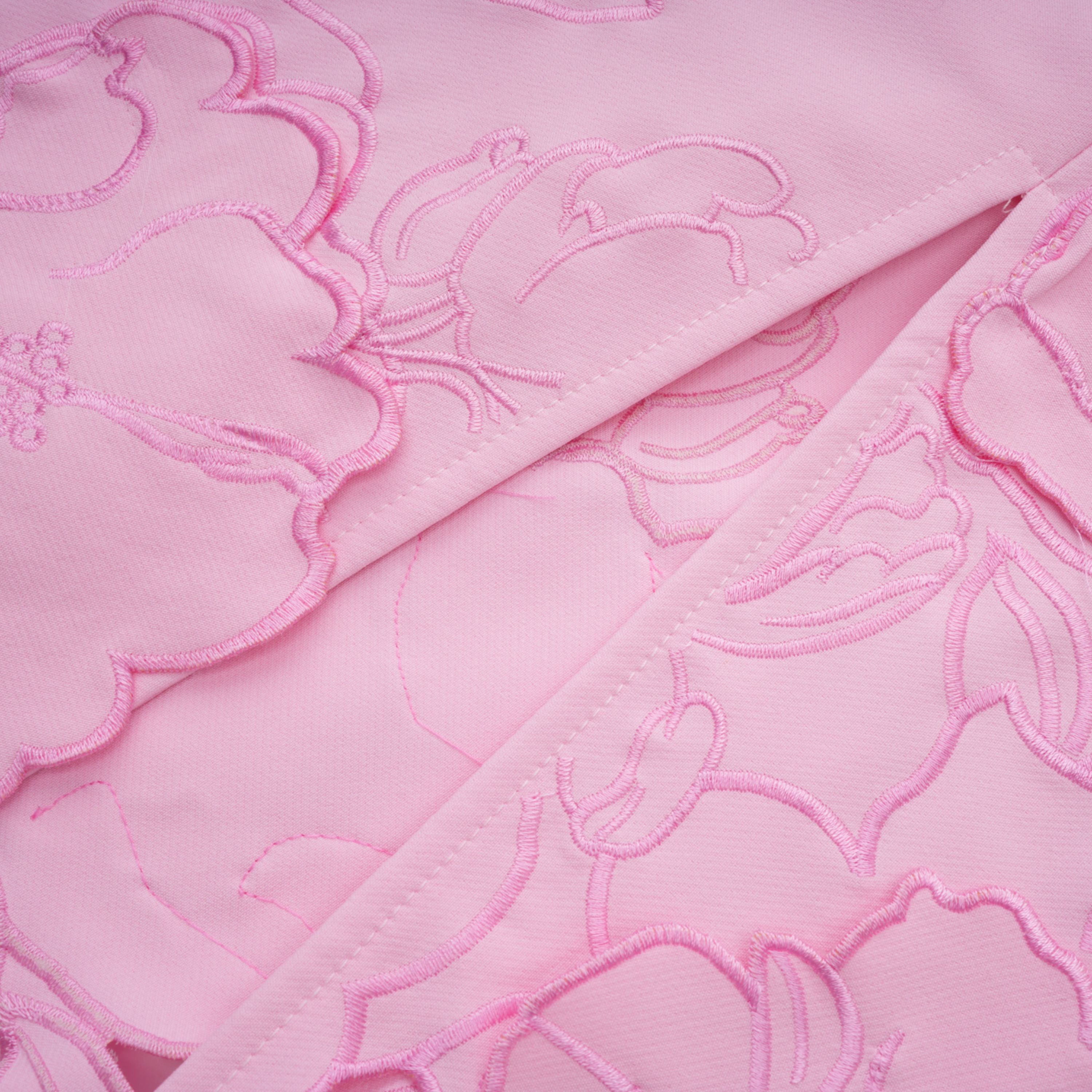 Pink strapless midi dress with a cutout floral hem