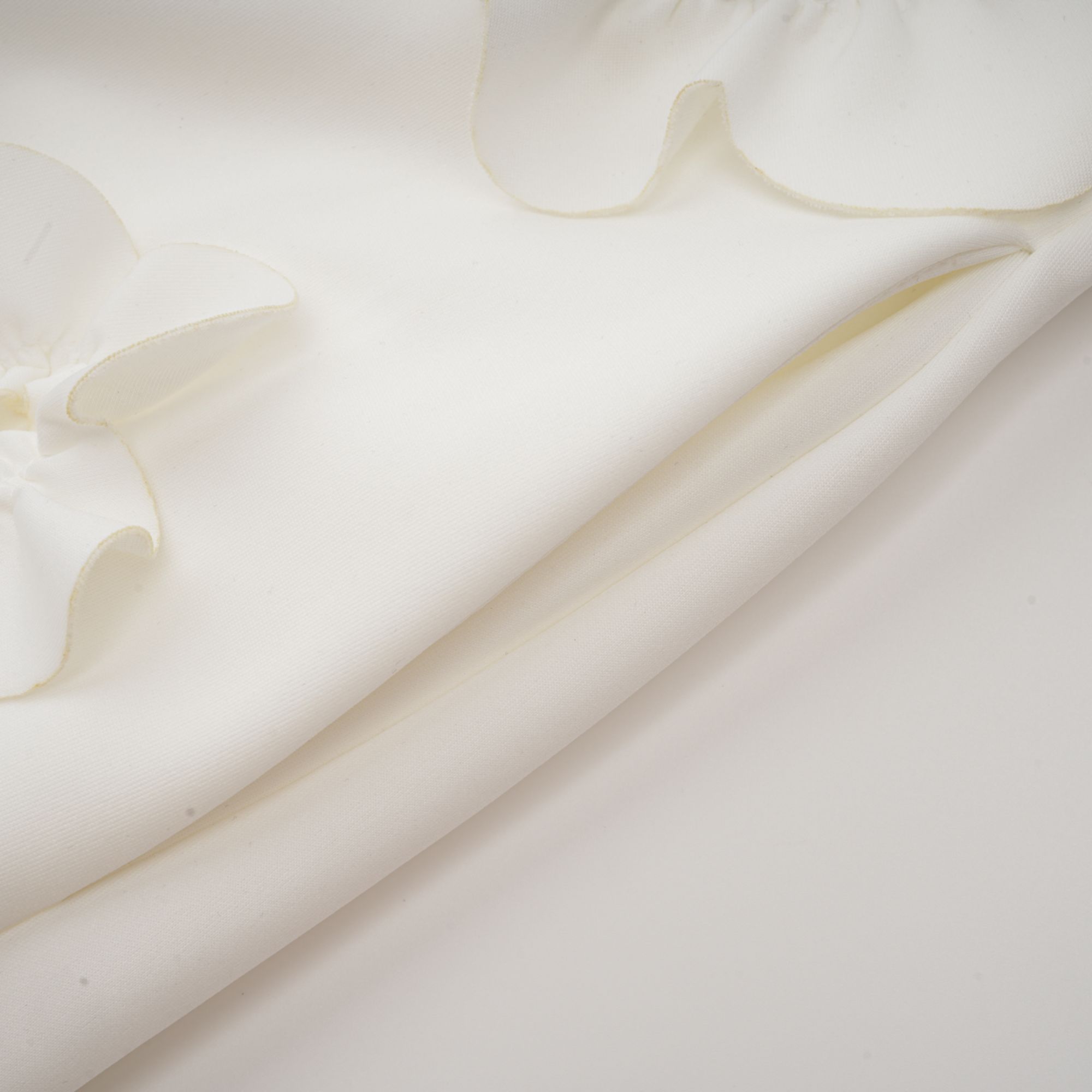 White sleeveless high-neck midi dress with 3D floral embellishments