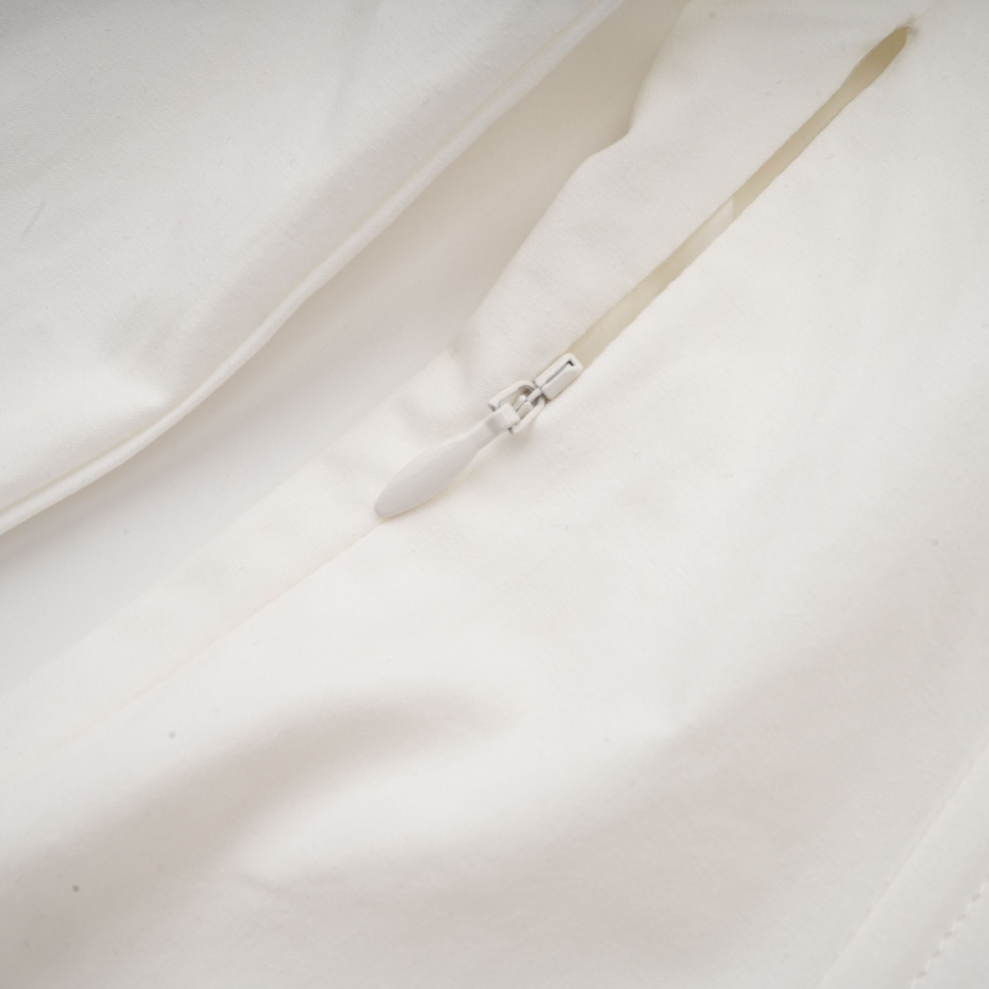 White long-sleeve corset shirt dress with a draped mini skirt