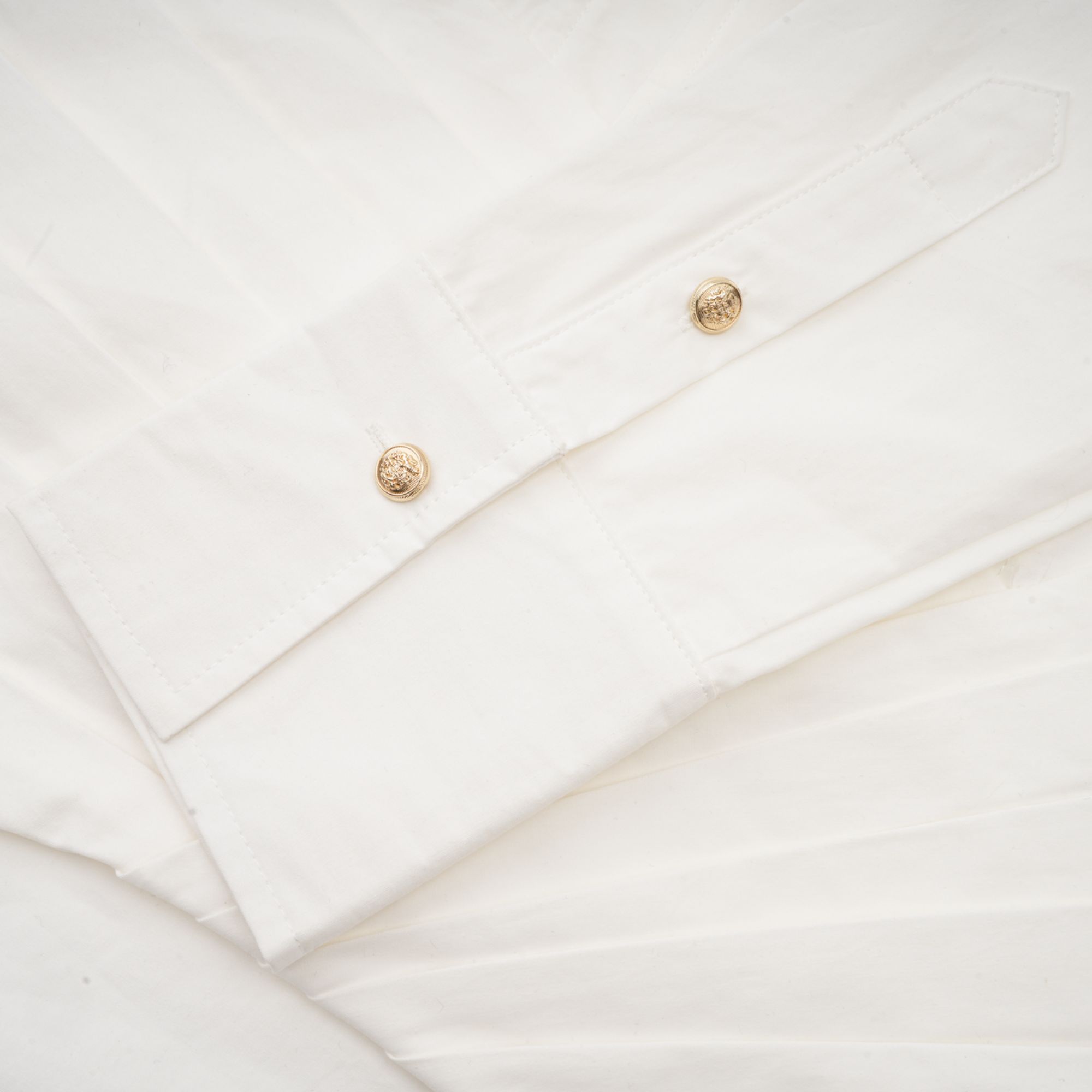 White long-sleeve corset shirt dress with a draped mini skirt