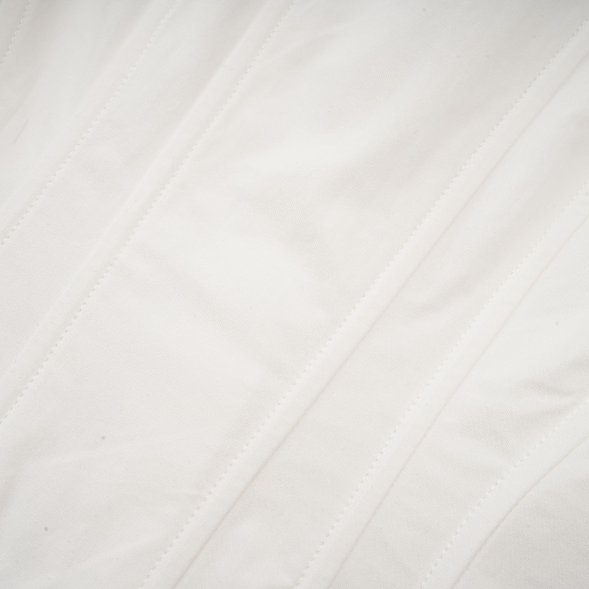 White long-sleeve corset shirt dress with a draped mini skirt