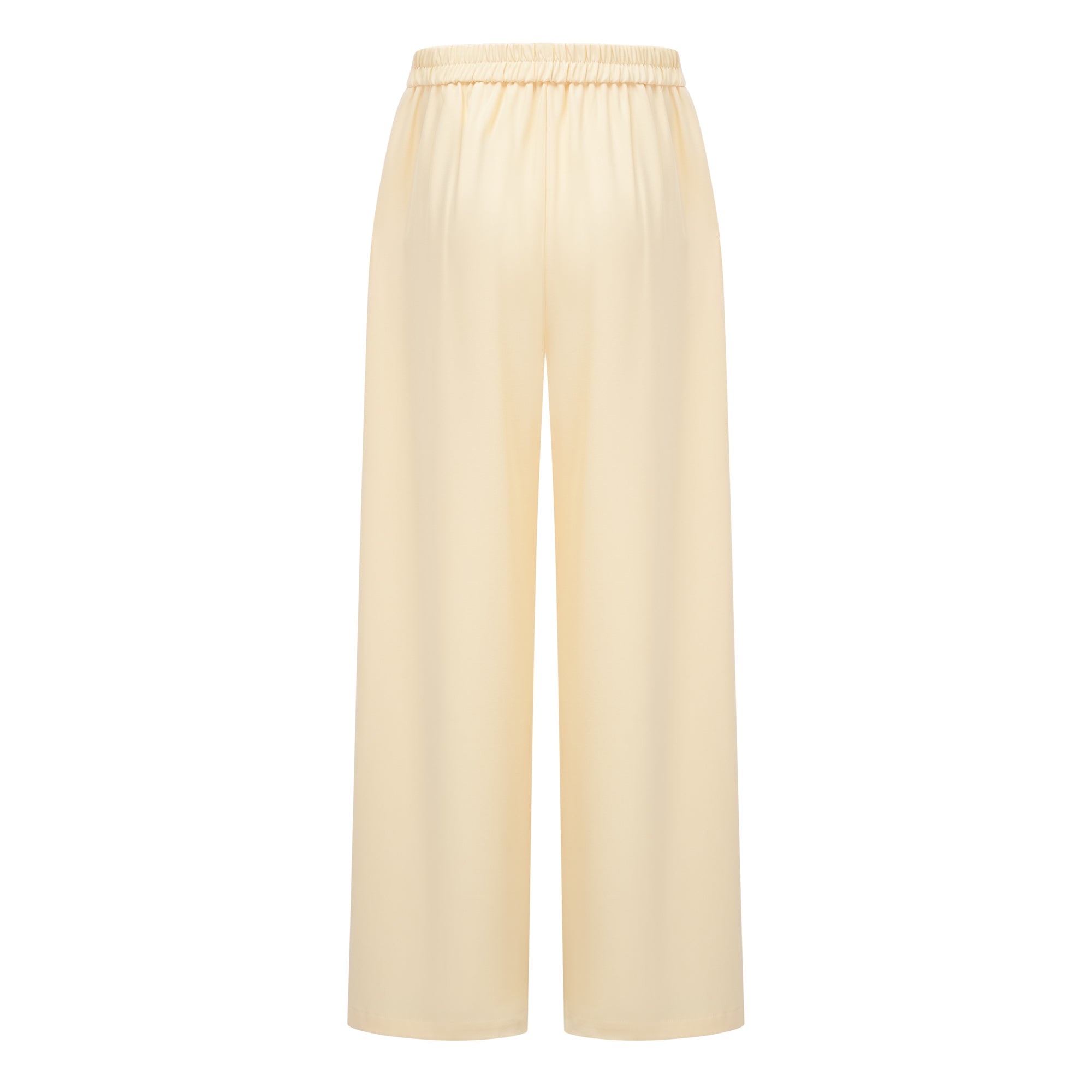 Pale yellow top and trousers set with an asymmetric blazer bodice, draped sheer neckline, and cape panels