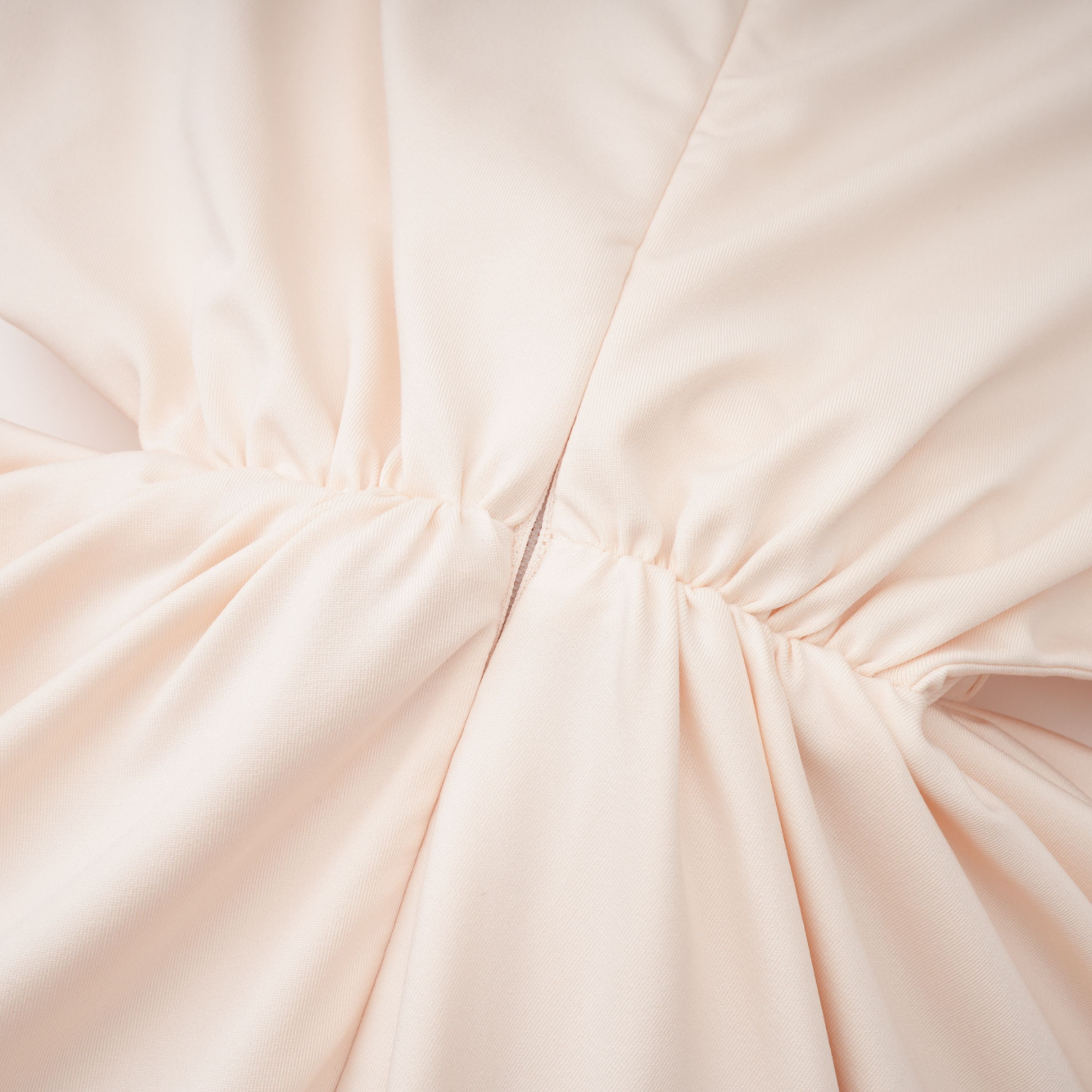Cream halter maxi dress with waist cutouts and a knotted draped bodice