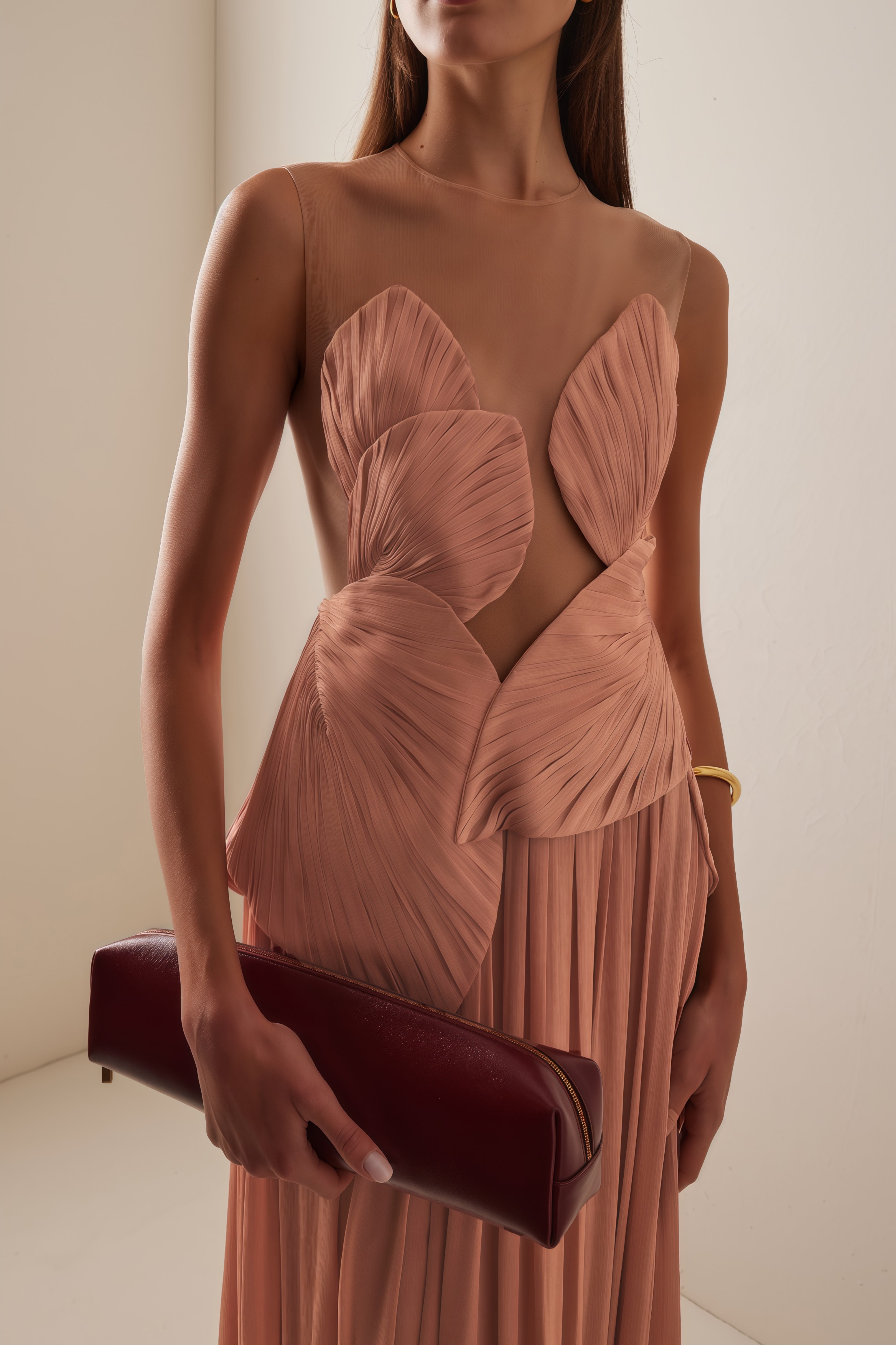Dusty rose pleated maxi dress featuring a structured geometric bodice with a sheer mesh illusion neckline