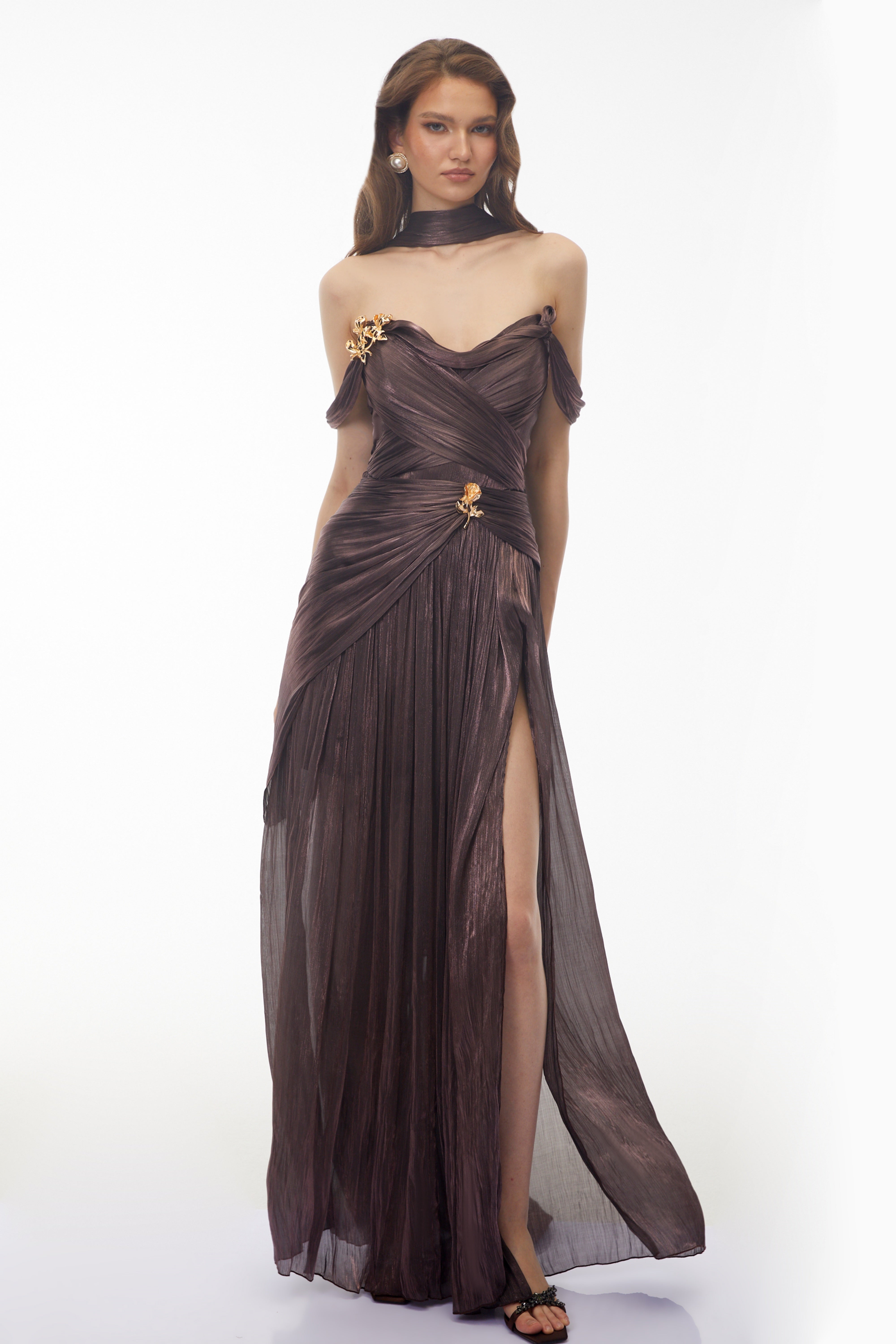 Metallic bronze maxi dress with an off-the-shoulder draped bodice, matching neck scarf, and high leg slit