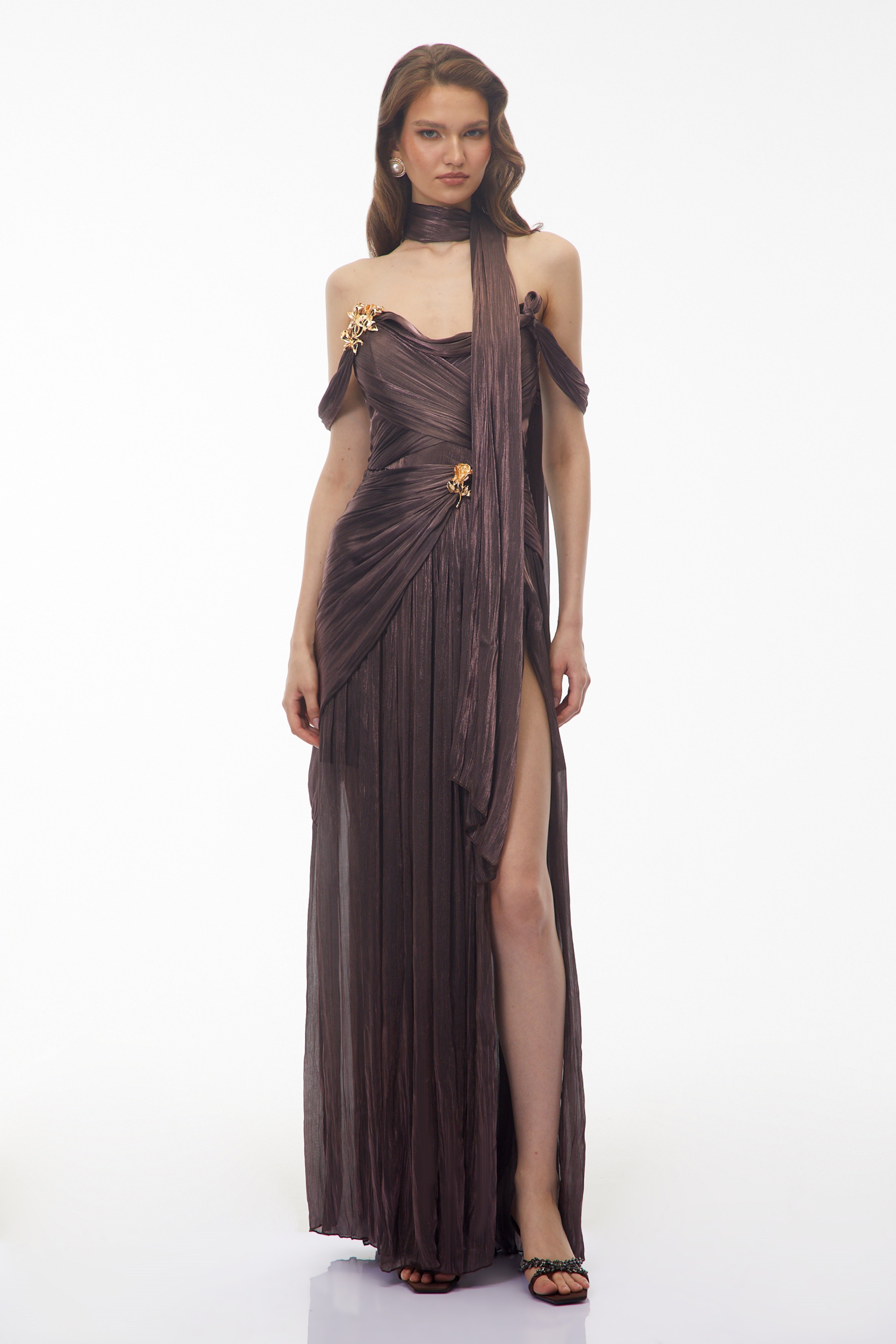 Metallic bronze maxi dress with an off-the-shoulder draped bodice, matching neck scarf, and high leg slit