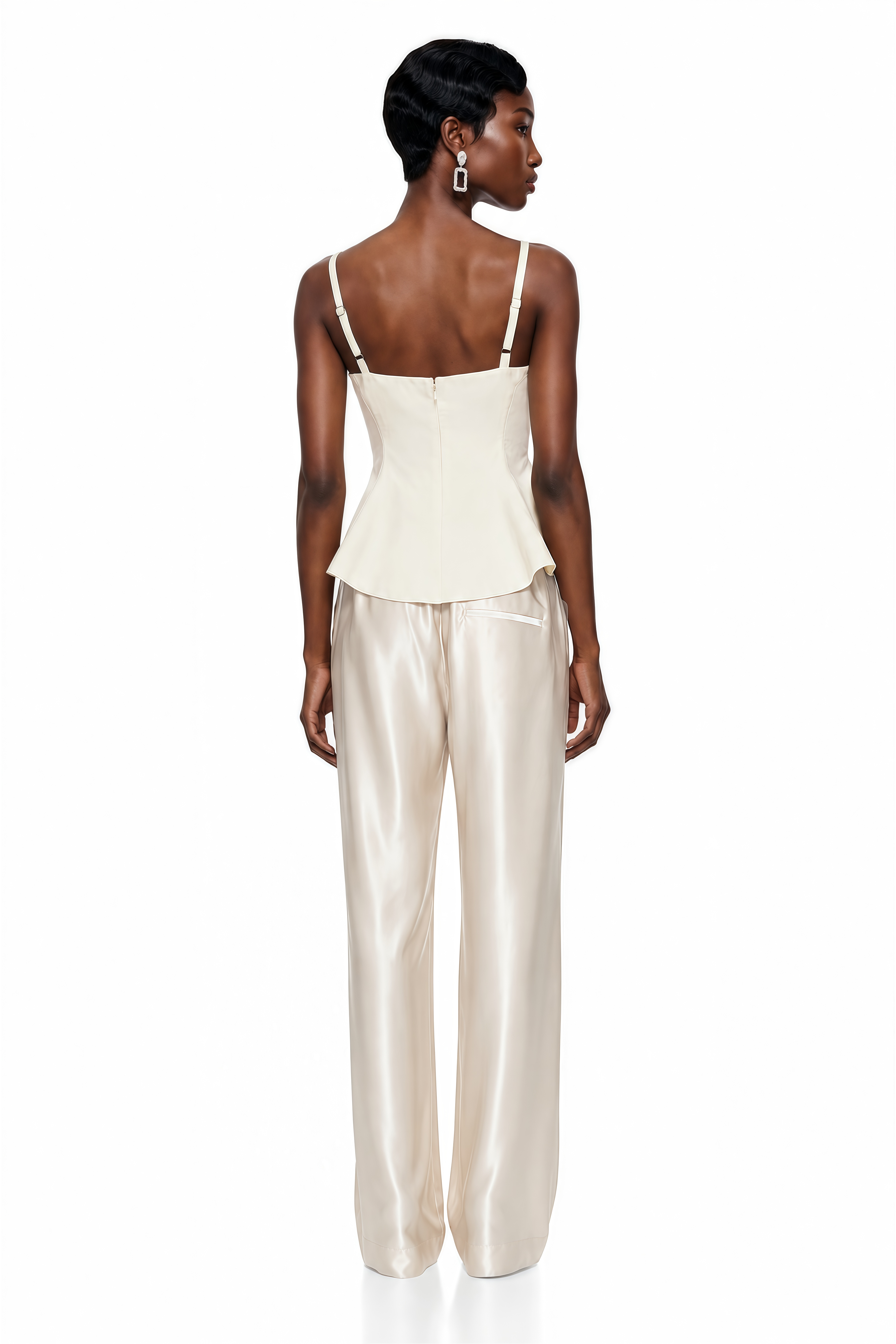 Cream two-piece set featuring a scoop-neck peplum top with an asymmetric hem and satin wide-leg trousers