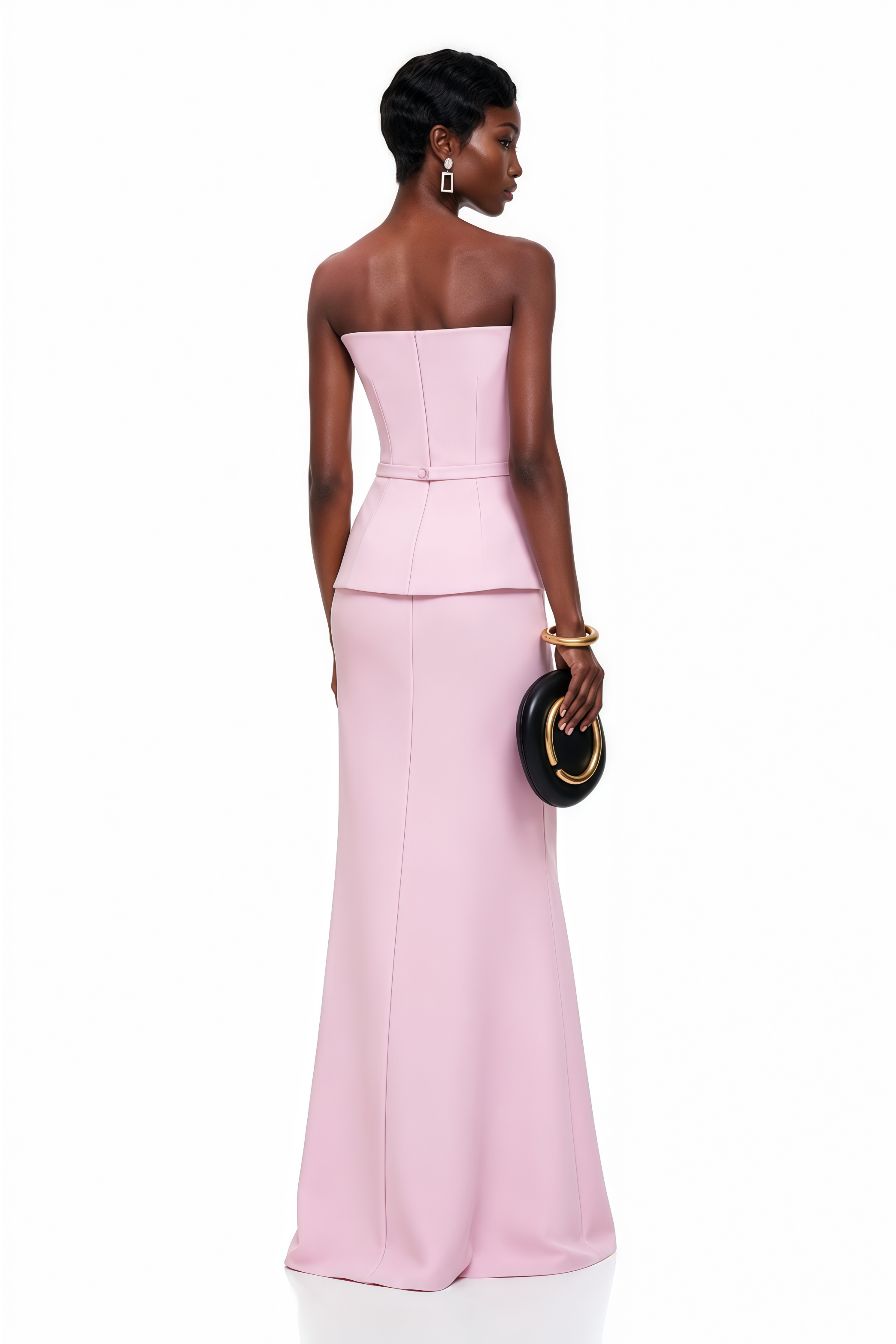 Light pink strapless maxi dress featuring a structured bodice and a geometric asymmetric peplum waist