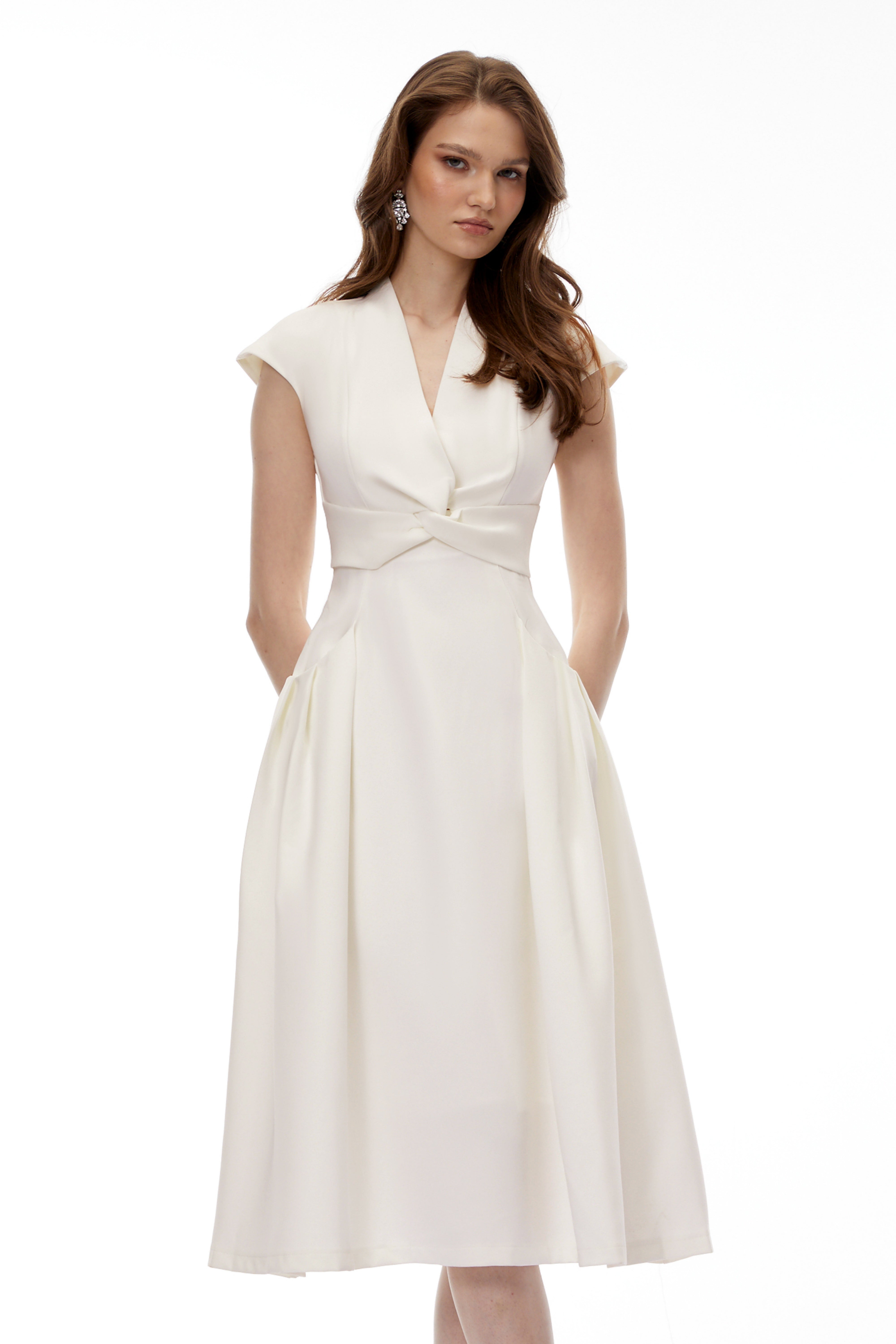 White midi dress with a surplice V-neckline, capped sleeves, and a structured A-line skirt