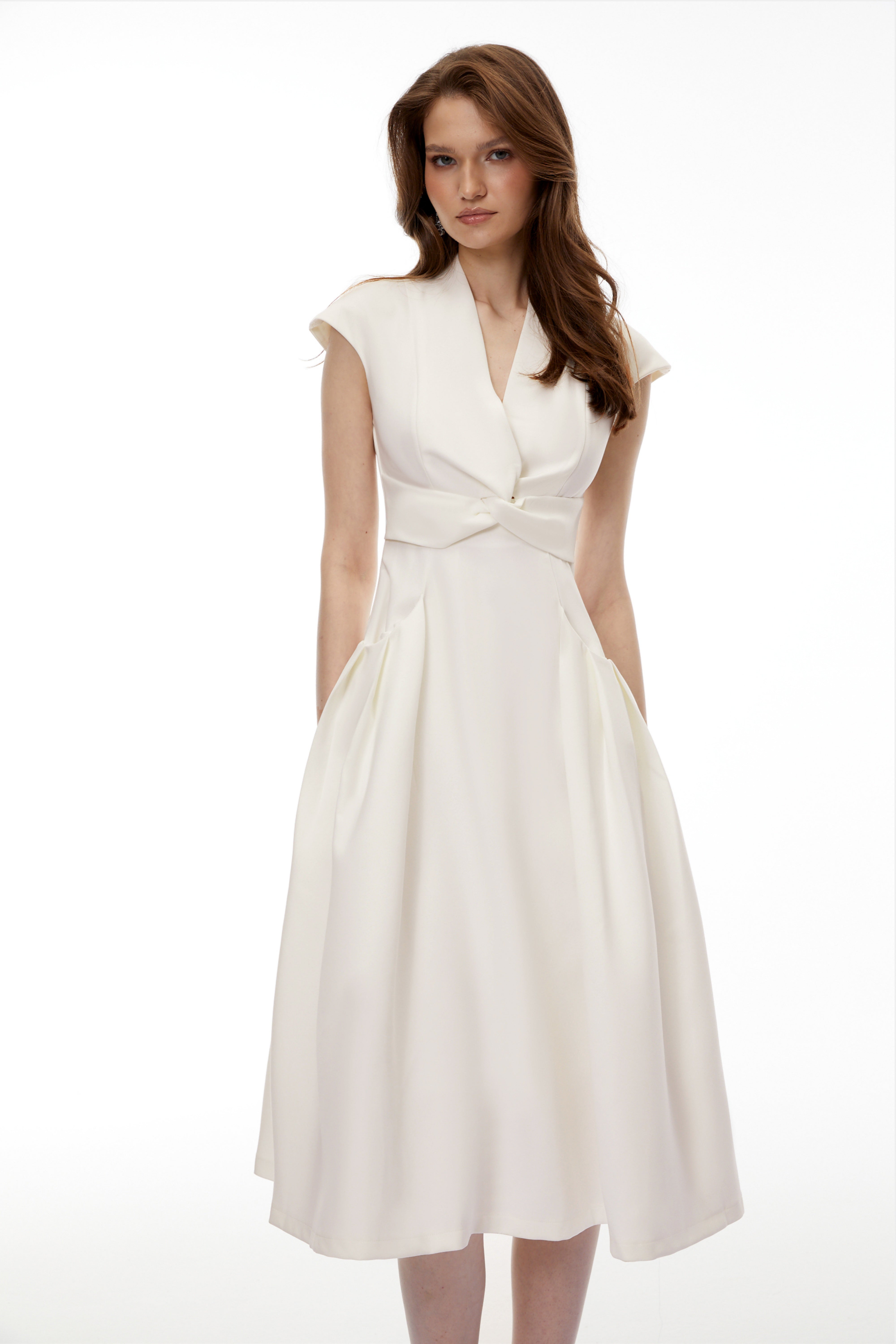 White midi dress with a surplice V-neckline, capped sleeves, and a structured A-line skirt