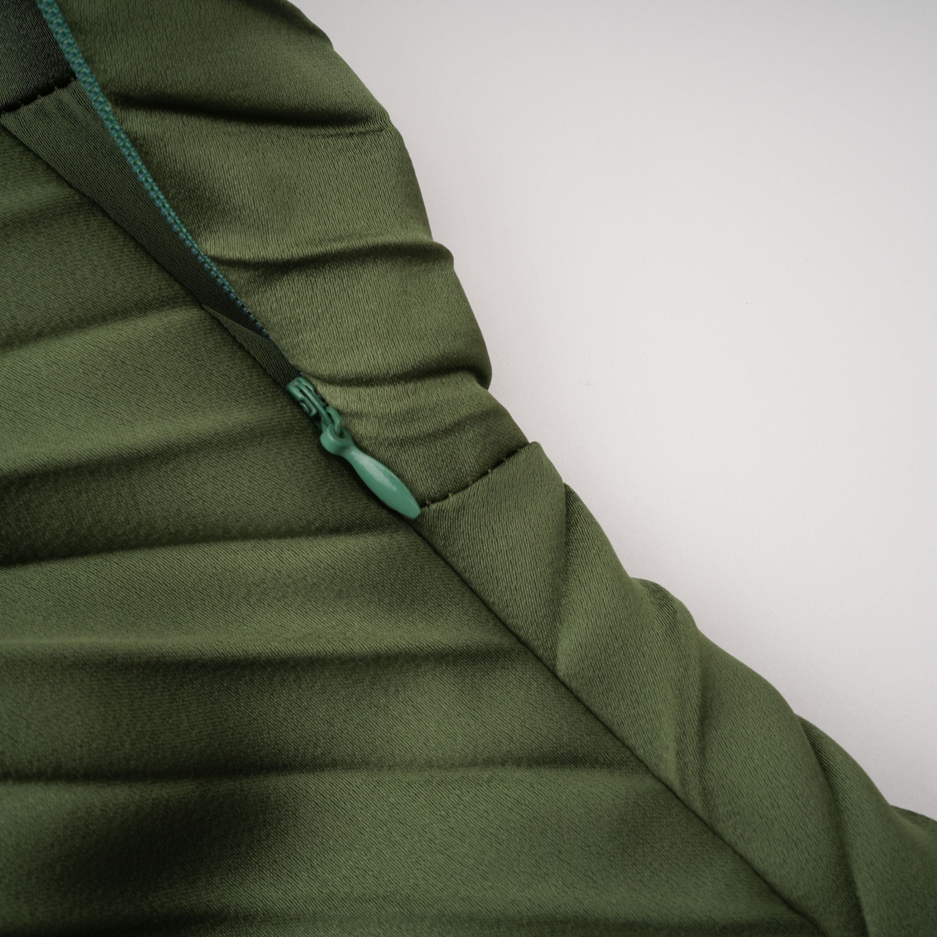 Olive green maxi dress with a pleated one-shoulder neckline and fully pleated draped skirt