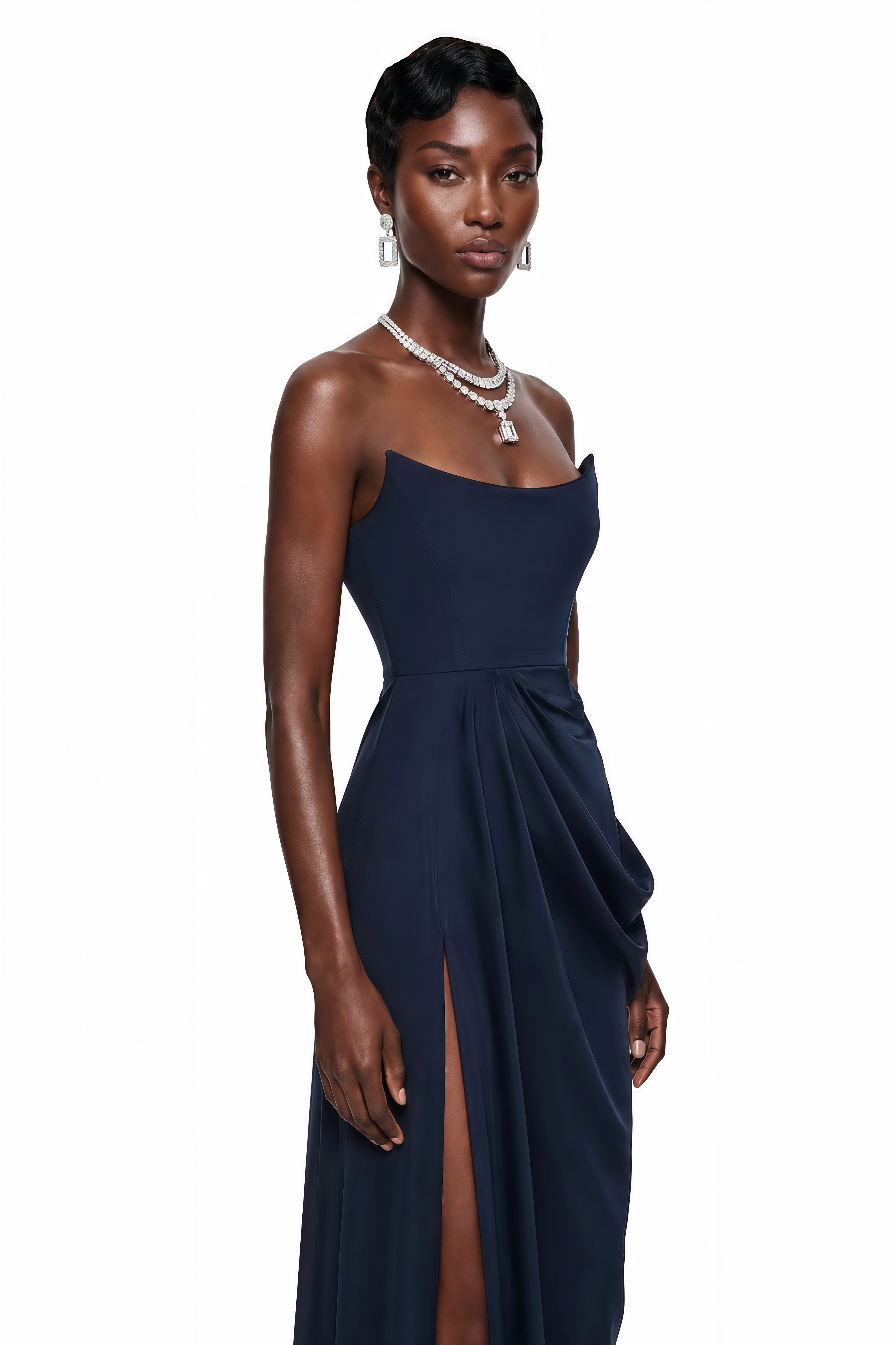 Navy blue strapless maxi dress with a fitted curved bodice, draped wrap skirt, and high thigh-high slit