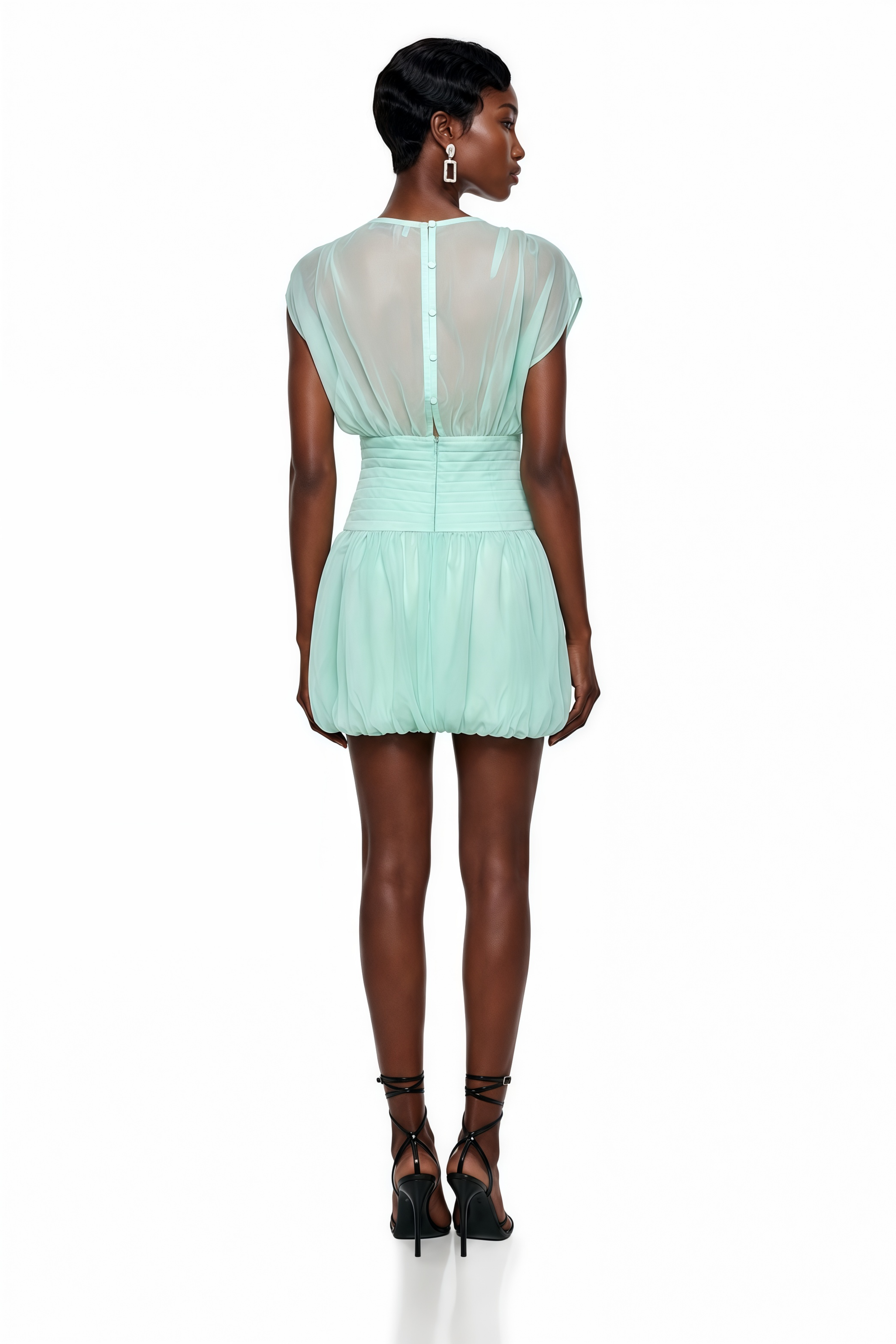 Mint green mini dress featuring a draped plunging V-neckline with bow closures, a ruched waistband, and a voluminous bubble skirt