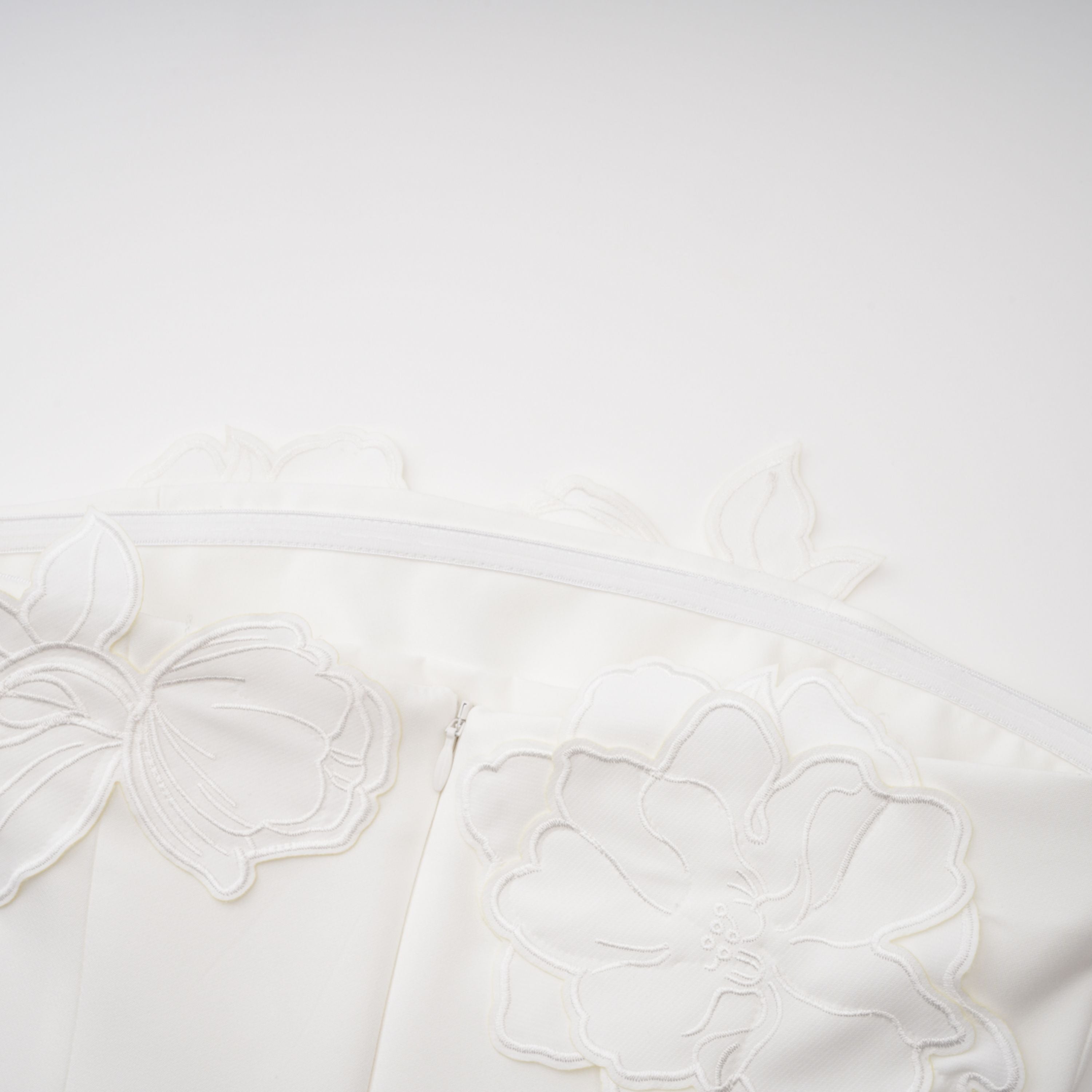 White strapless mini dress with 3D floral appliqués