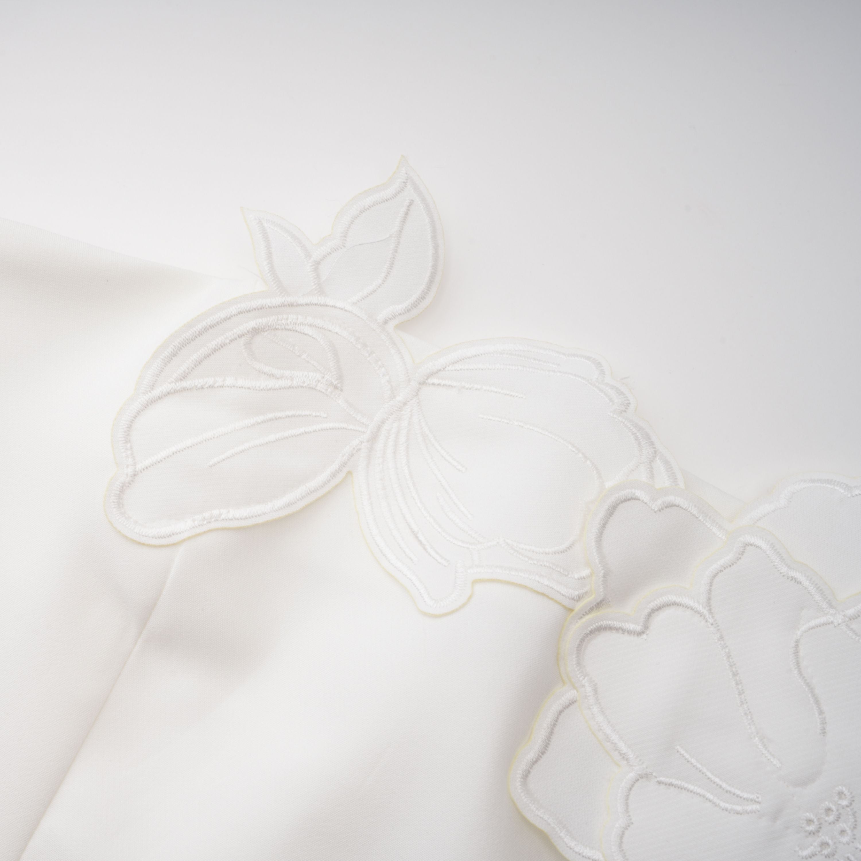 White strapless mini dress with 3D floral appliqués