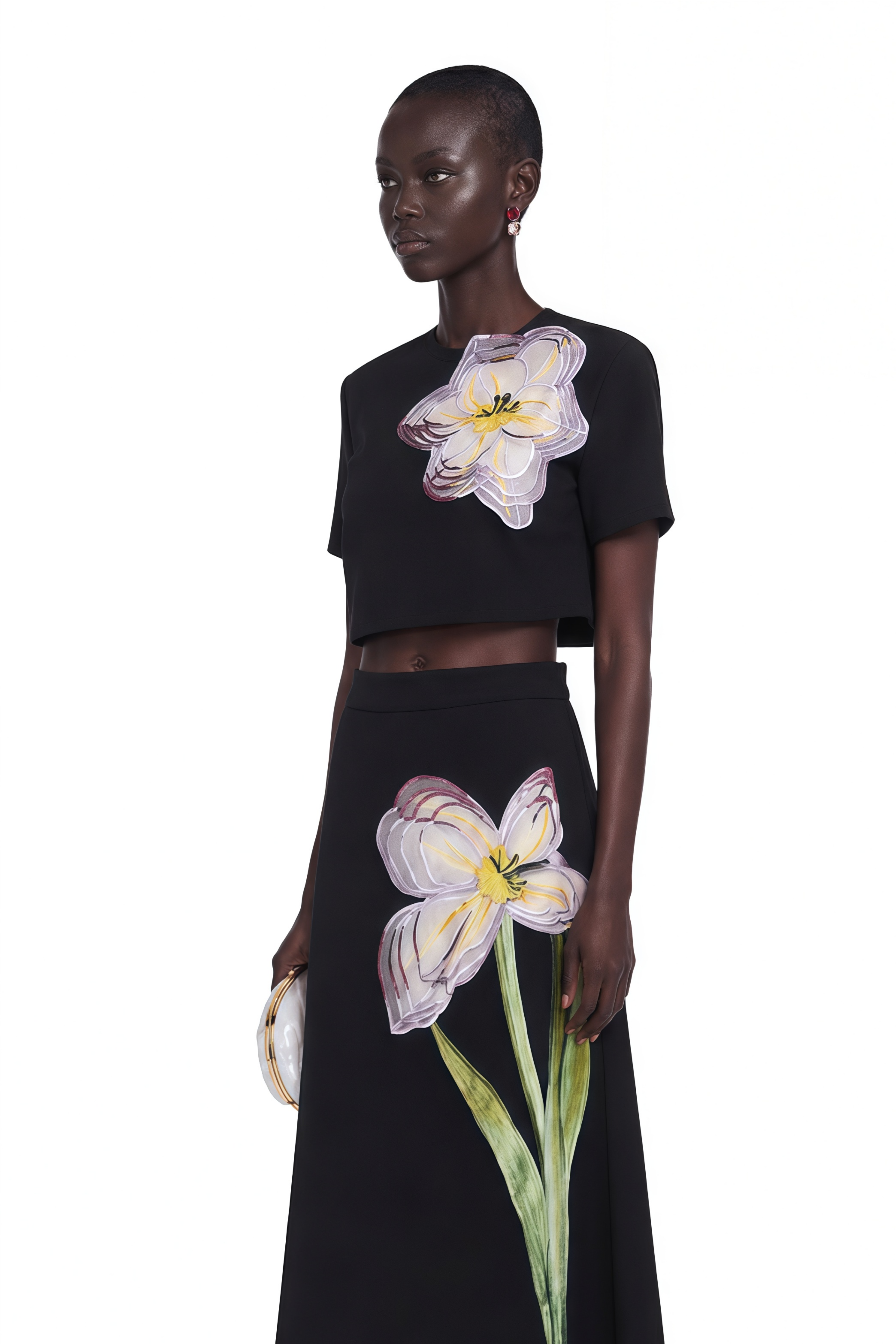 Black short-sleeve crop top and maxi skirt set with large floral embroidery.