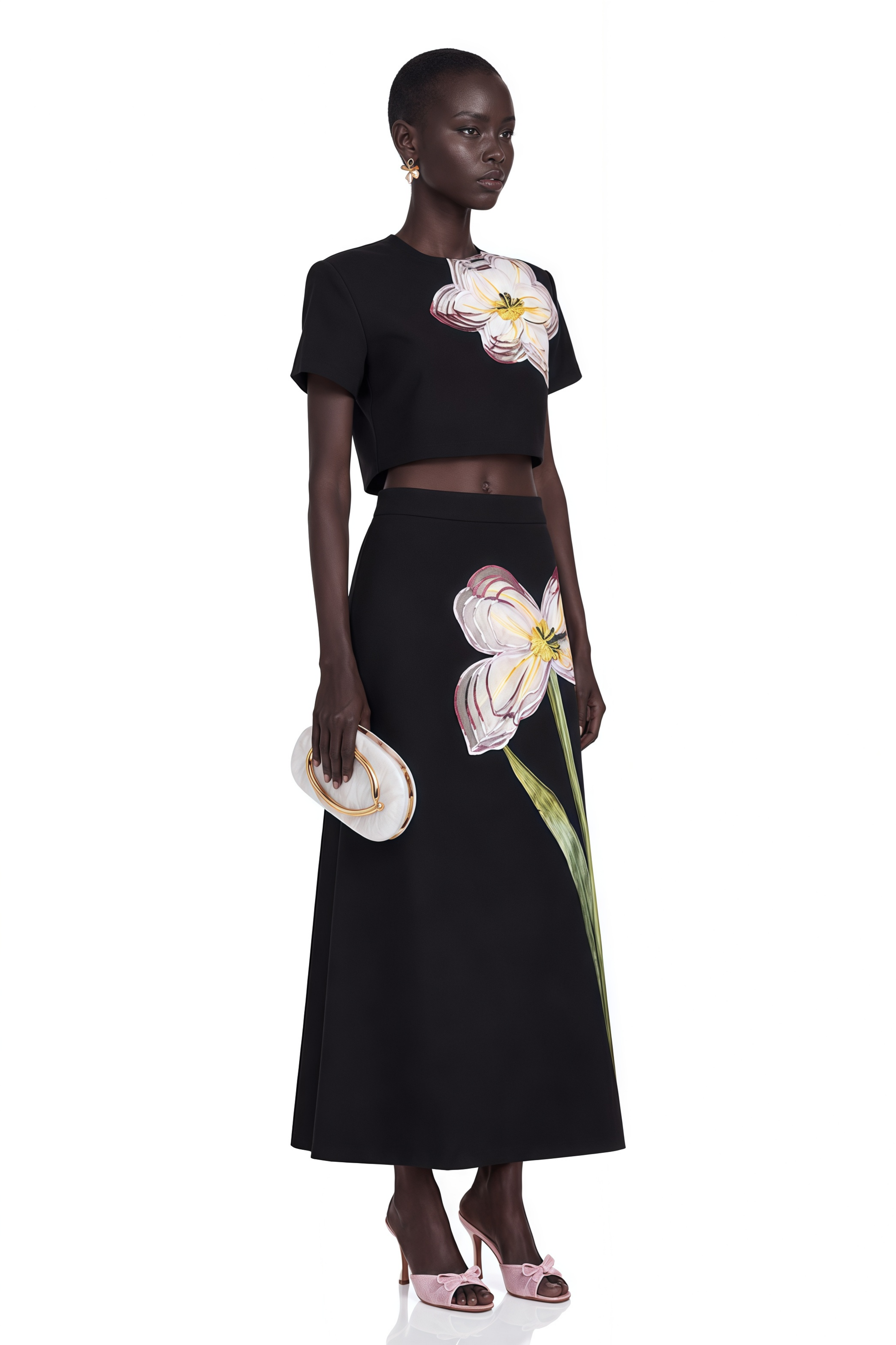 Black short-sleeve crop top and maxi skirt set with large floral embroidery.