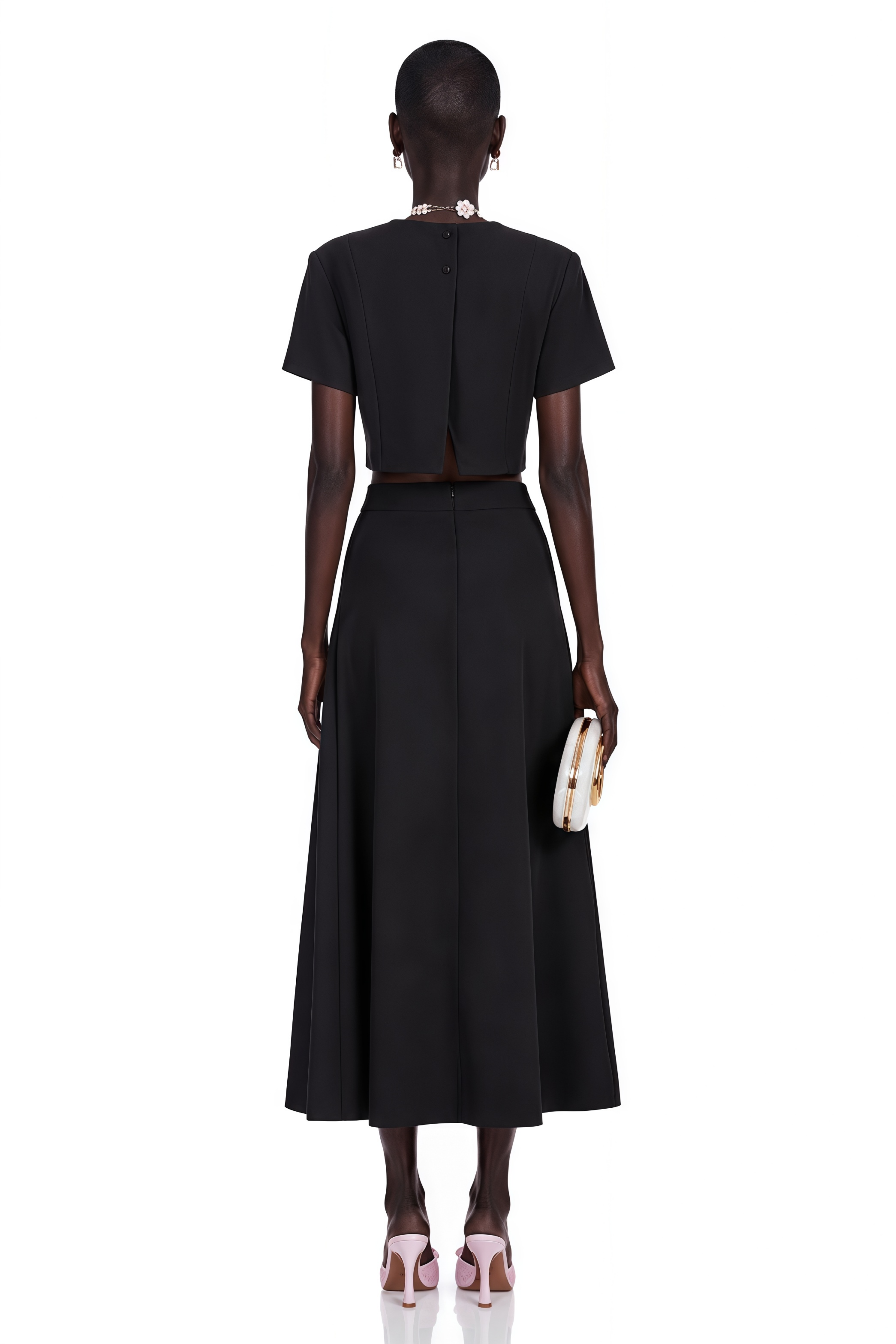 Black short-sleeve crop top and maxi skirt set with large floral embroidery.