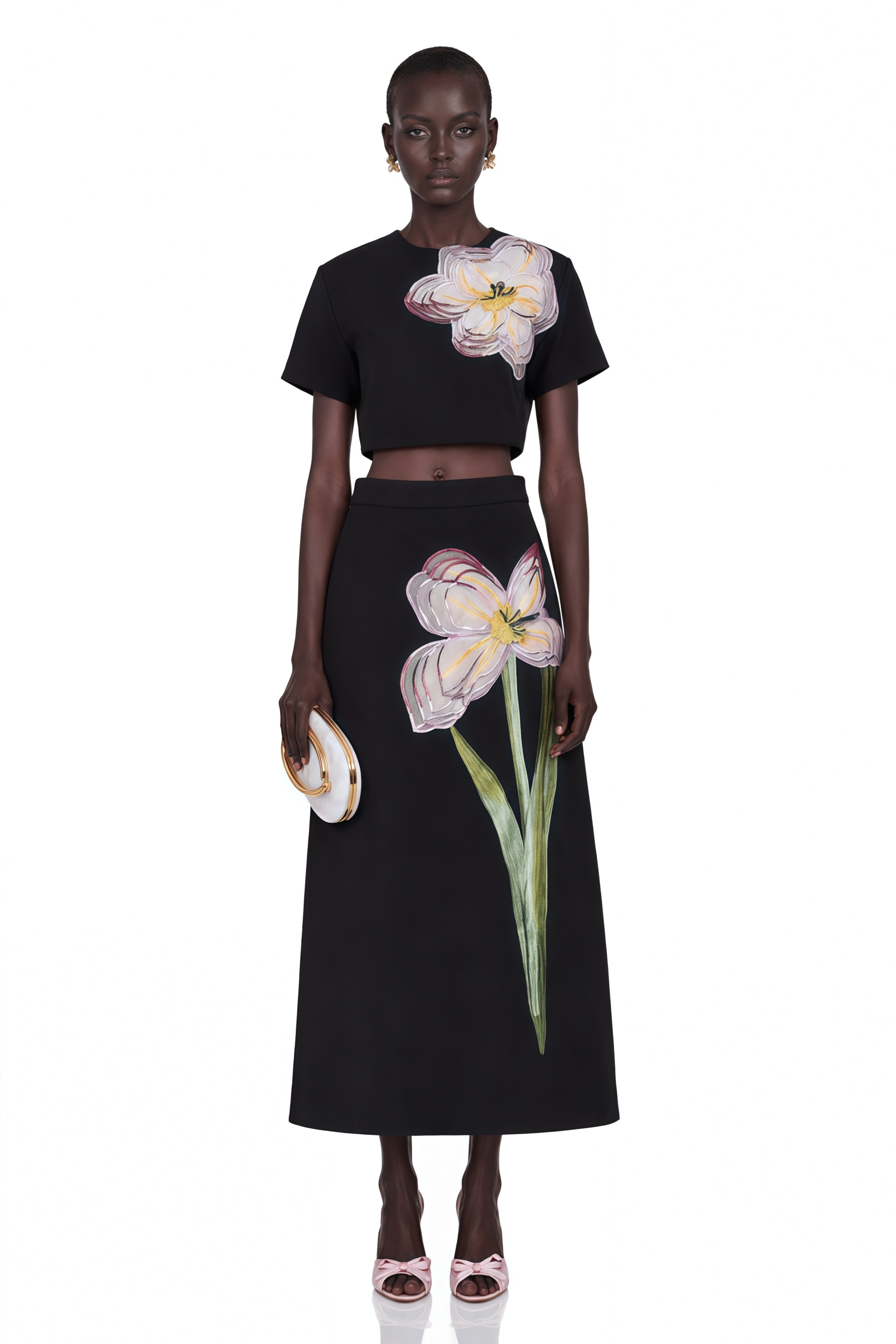 Black short-sleeve crop top and maxi skirt set with large floral embroidery.