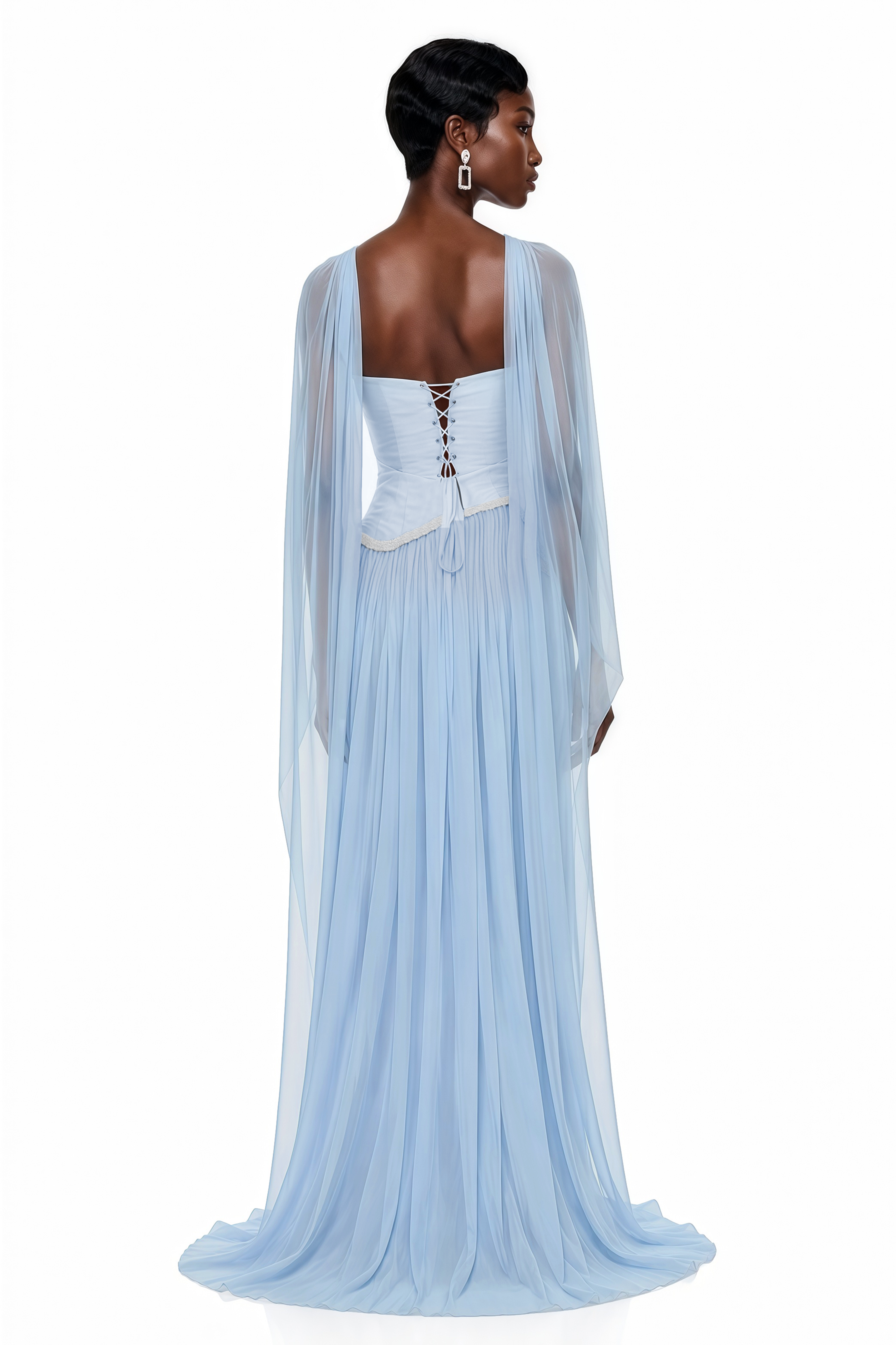Light blue pleated gown with embellished trim and draped cape
