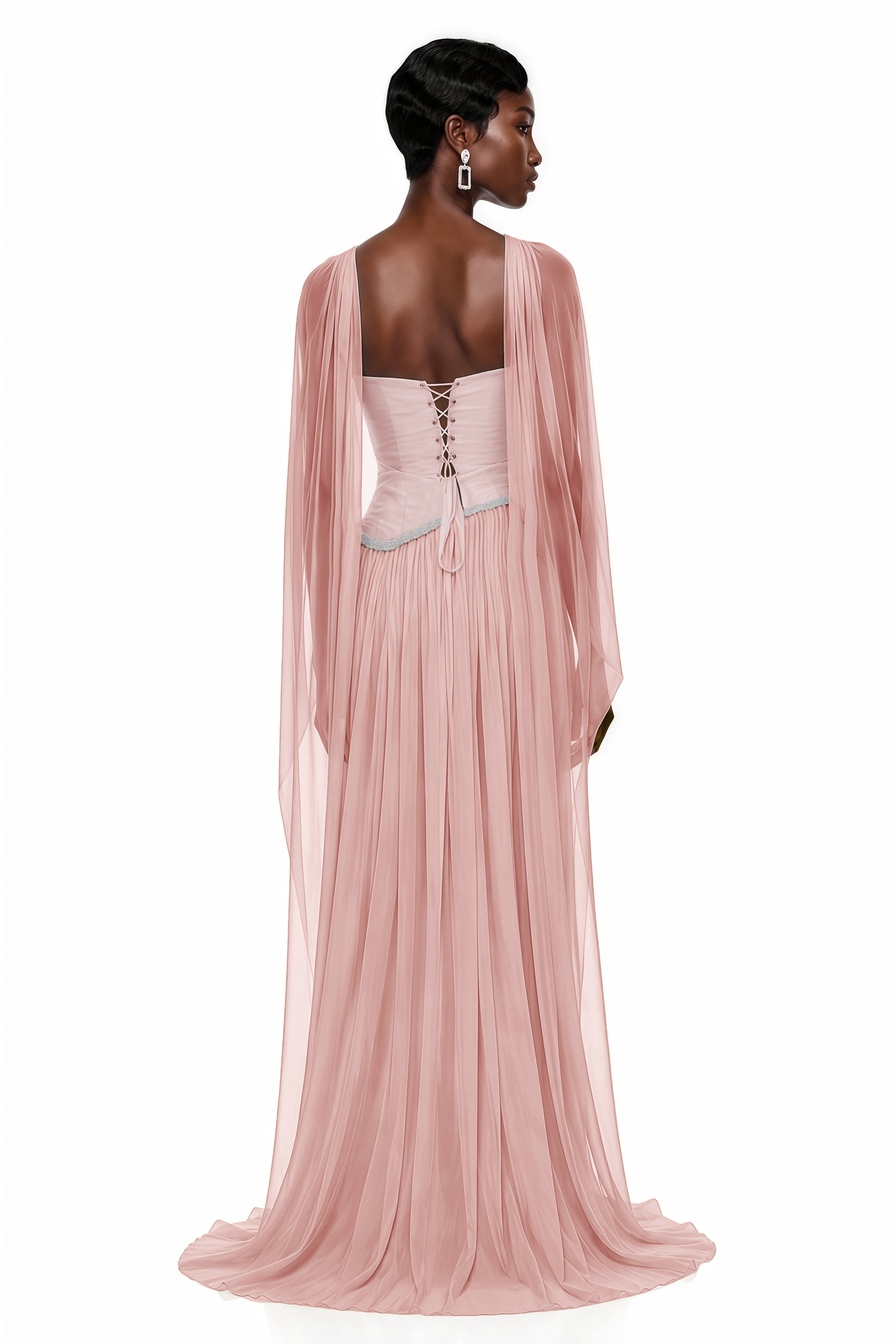 Blush pink pleated gown with embellished trim and draped cape