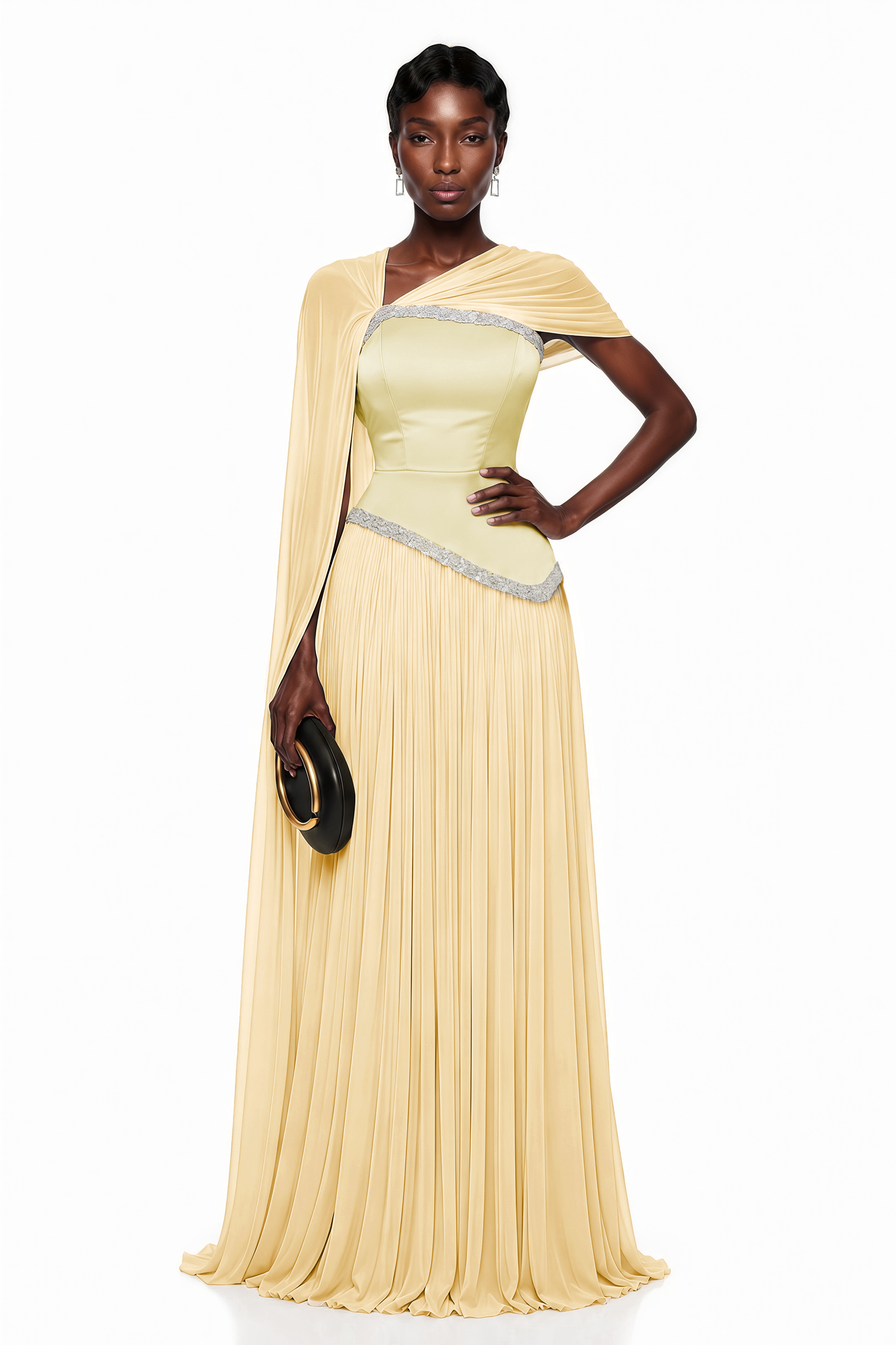 Pale yellow pleated gown with embellished trim and draped cape