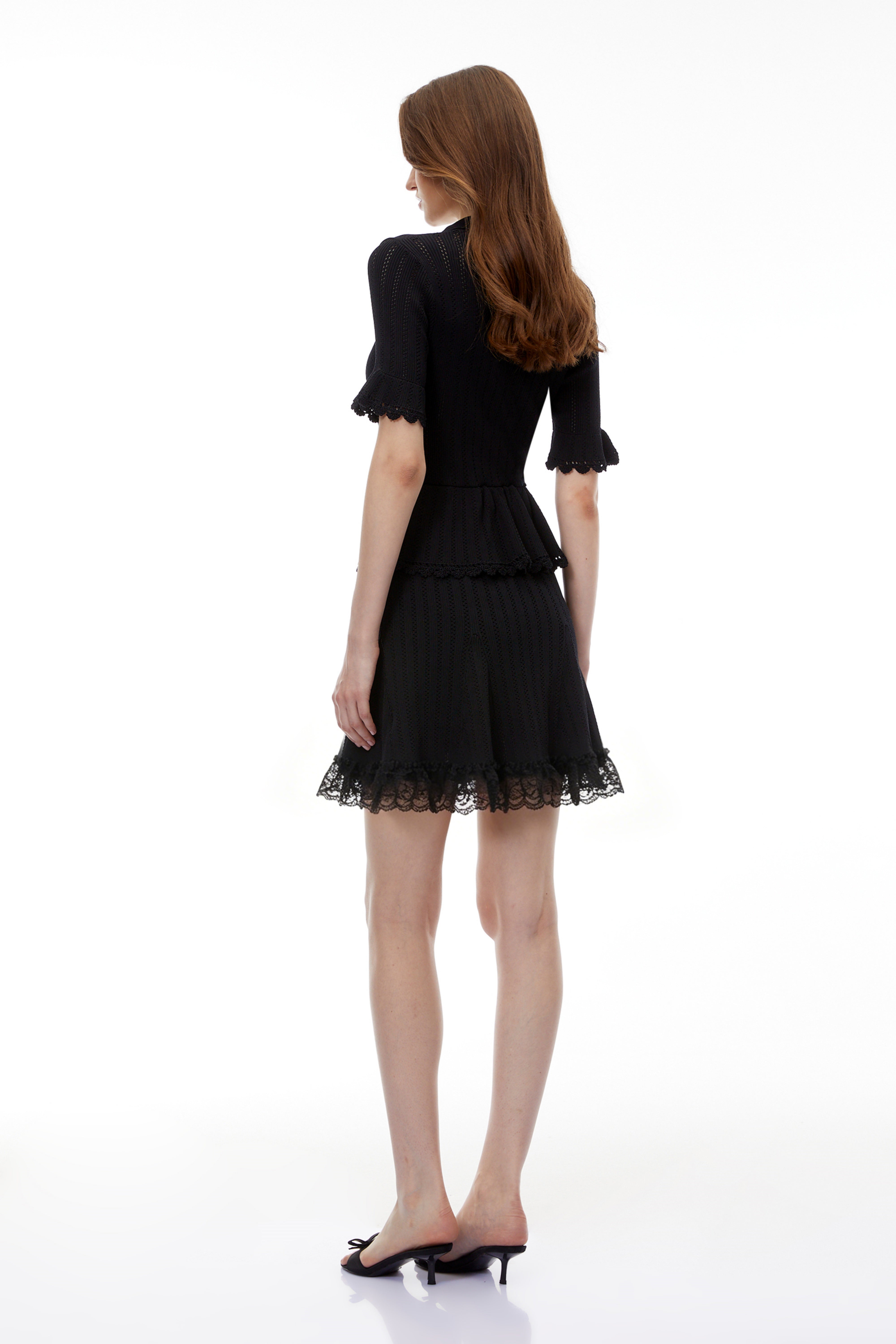 Black collared short-sleeve knit peplum mini dress with jewel buttons and a lace-trimmed hem