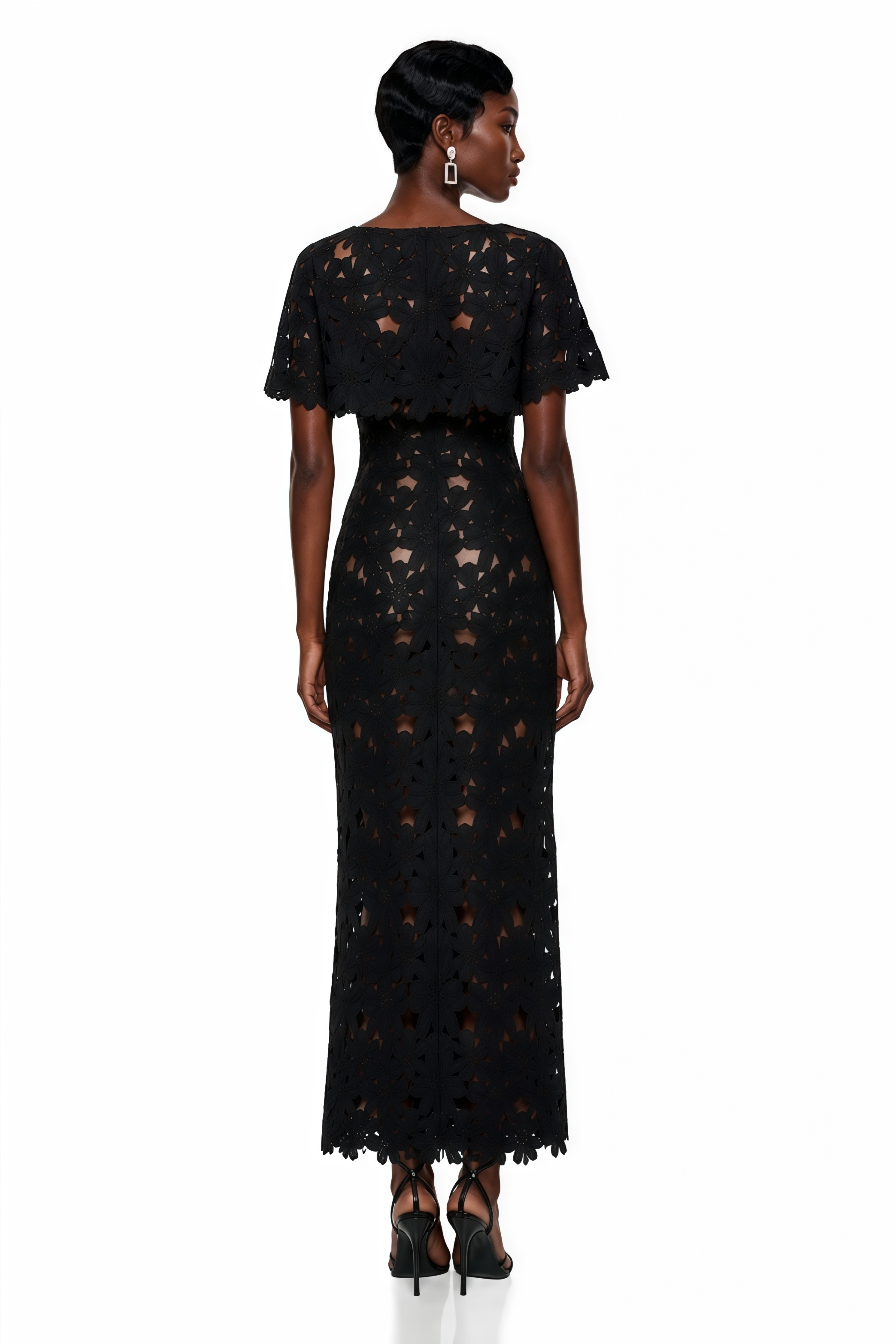 Black and white maxi dress with a cutout lace overlay, white corset bodice, and matching caplet shrug