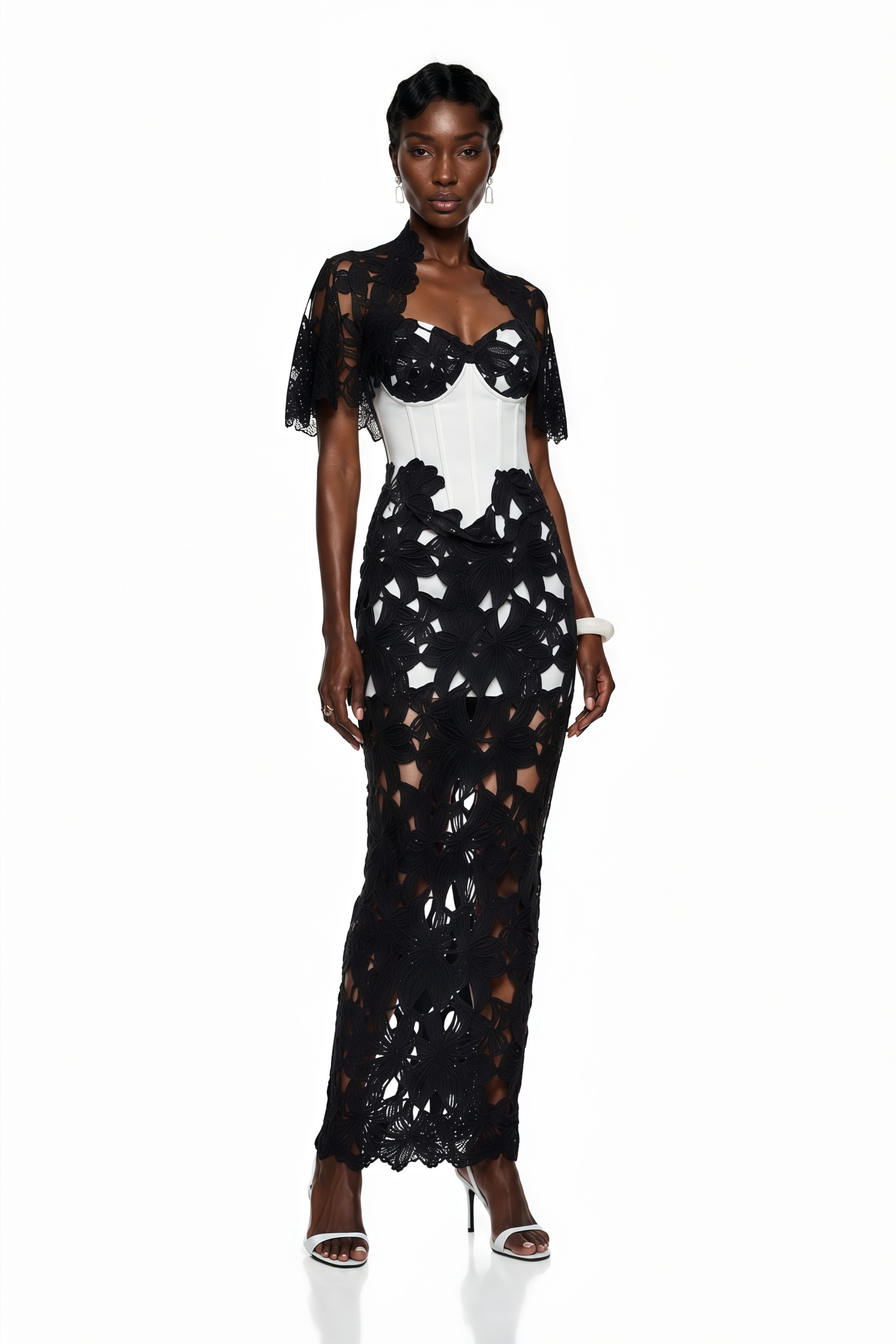 Black and white maxi dress with a cutout lace overlay, white corset bodice, and matching caplet shrug