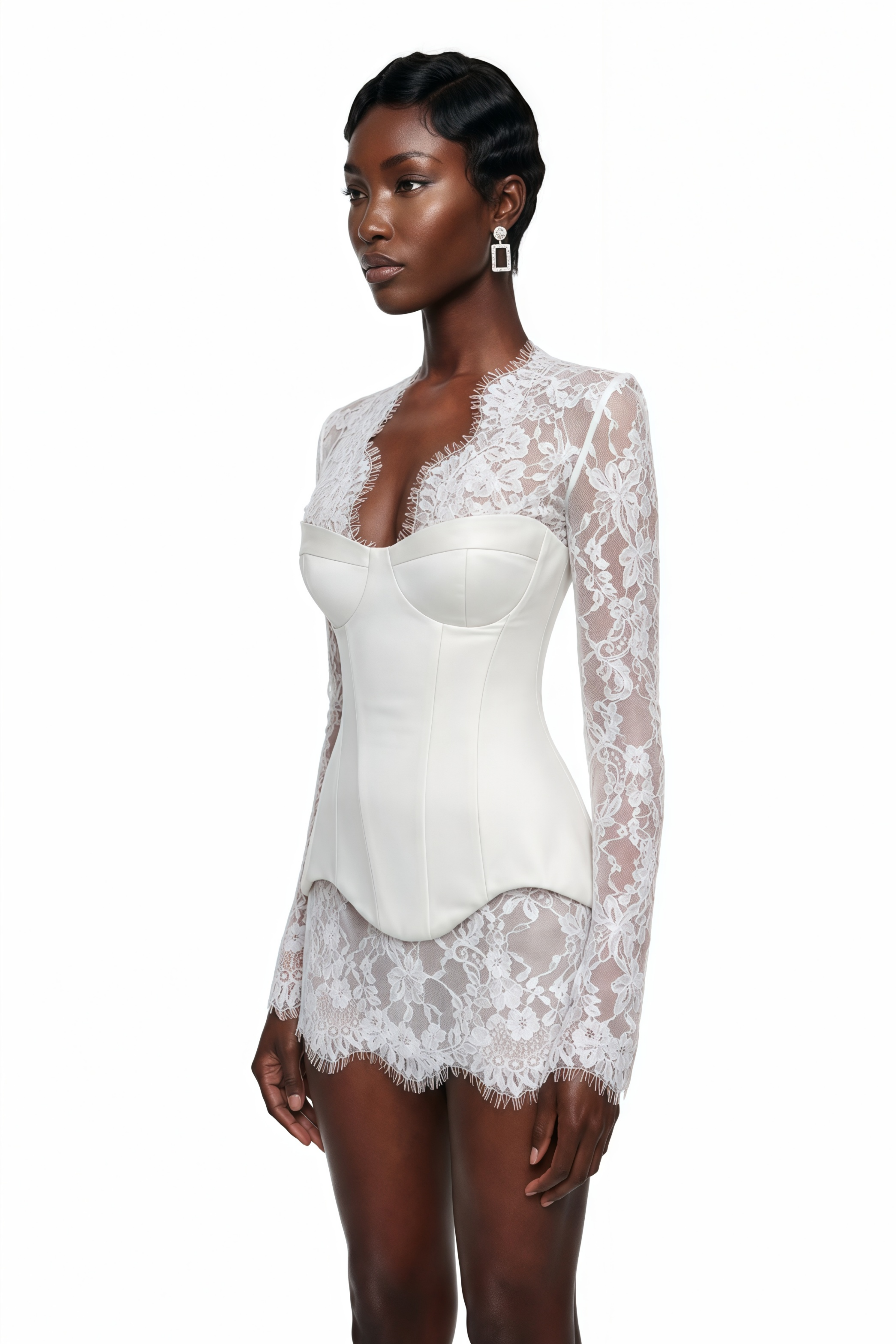 White mini dress featuring a long-sleeve sheer floral lace overlay and a structured corset bodice with an asymmetric hem