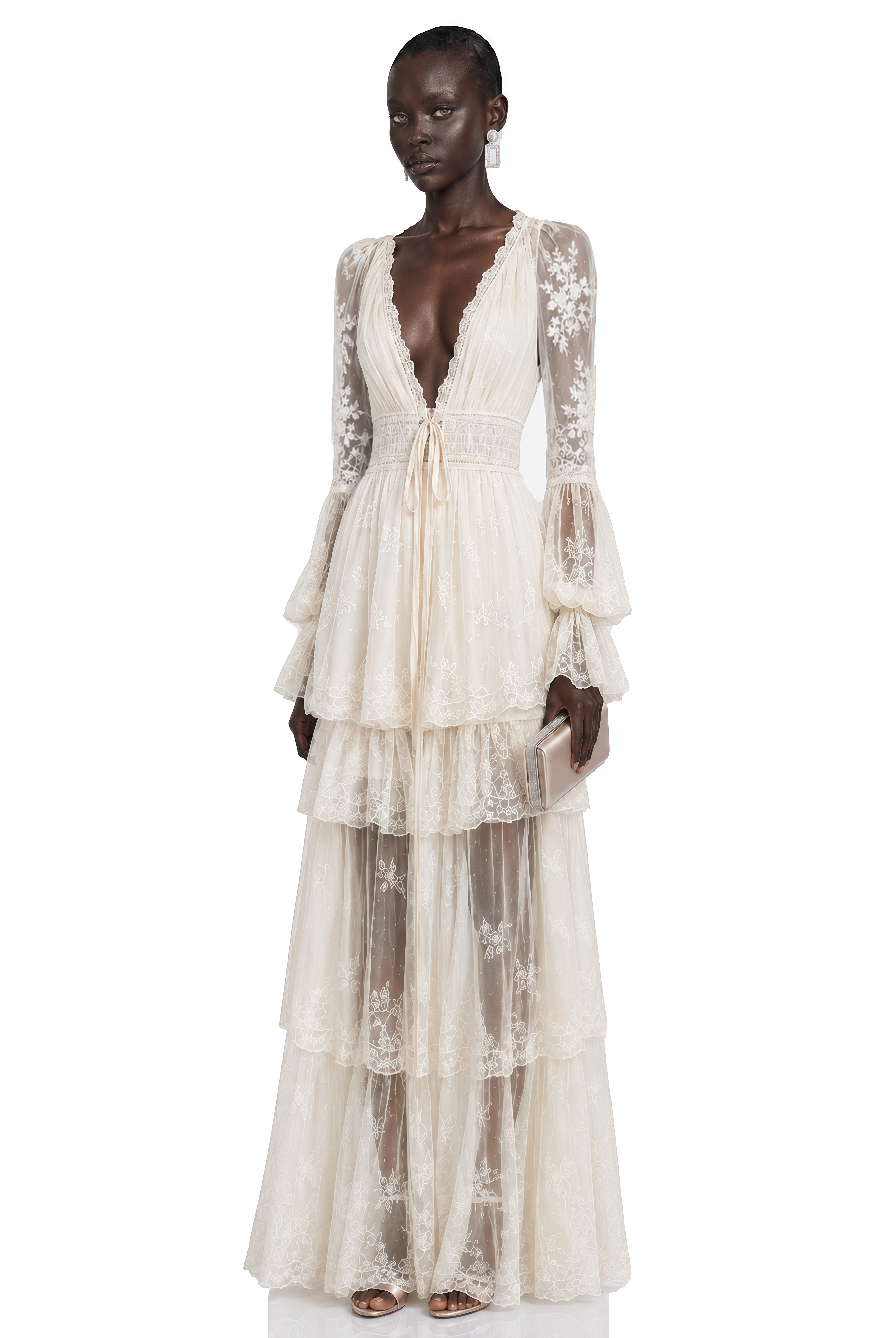Off-white lace long-sleeved gown with deep V-neckline and tiered skirt.