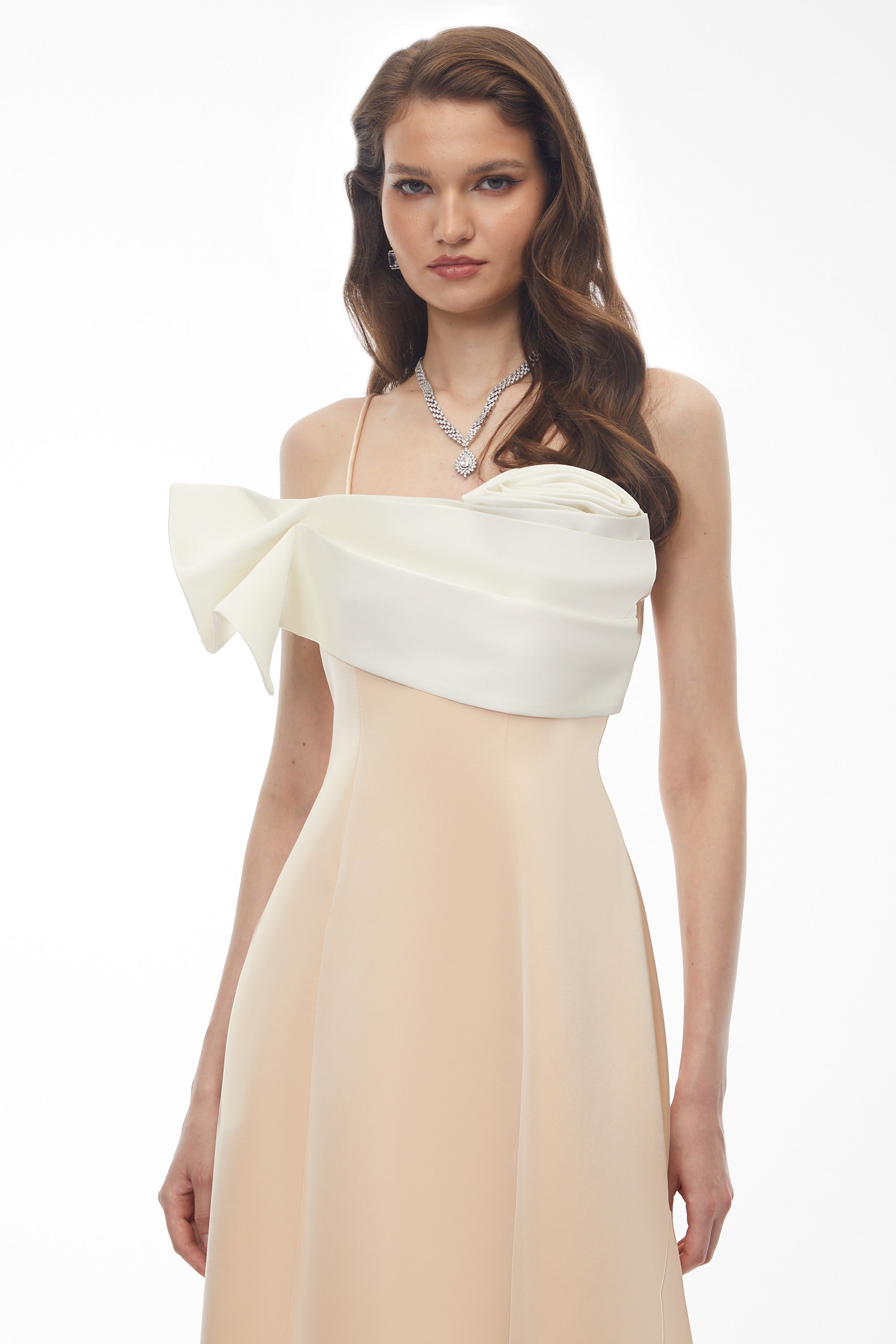 Cream midi dress featuring a white satin sculptural bodice and a slim shoulder strap