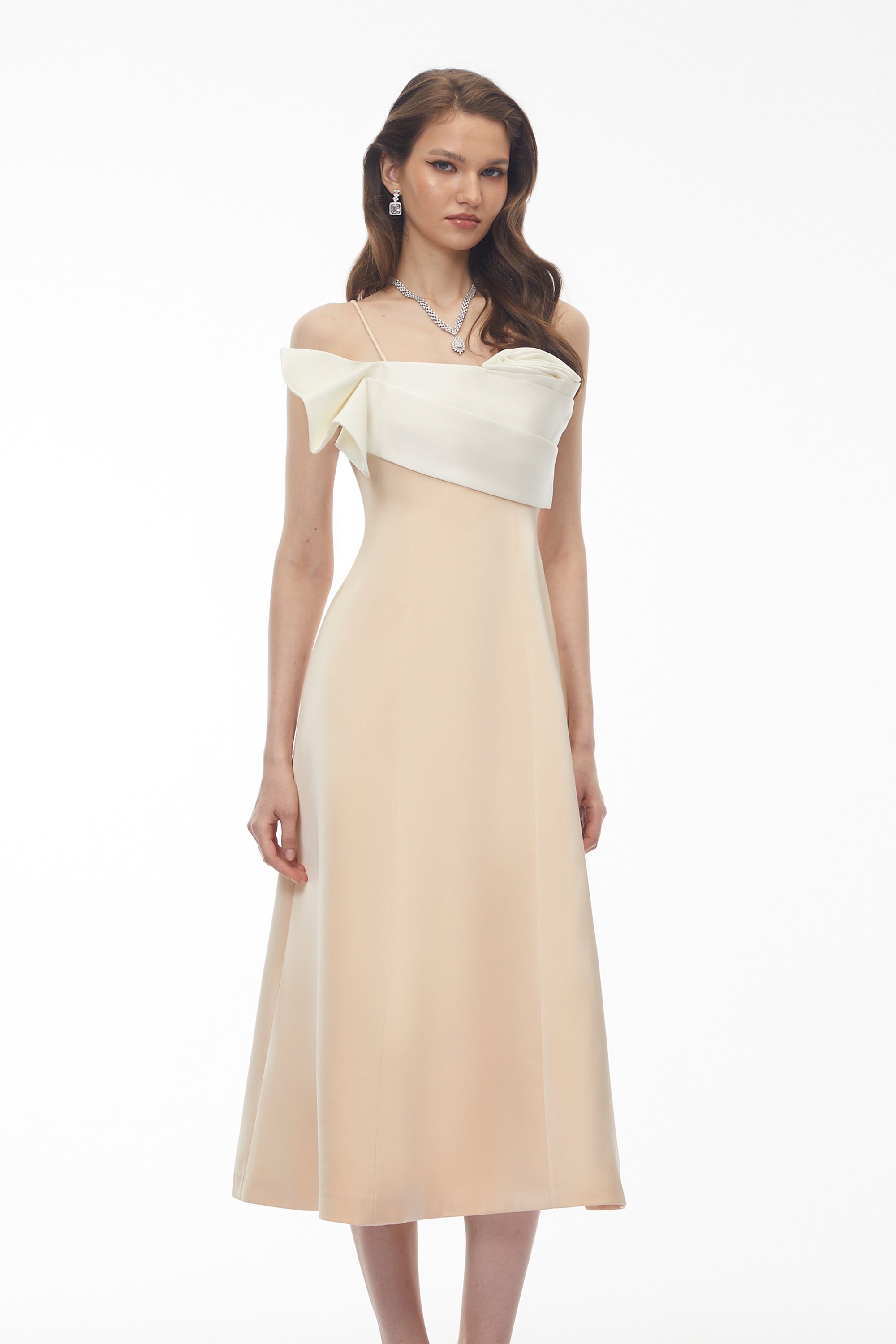 Cream midi dress featuring a white satin sculptural bodice and a slim shoulder strap