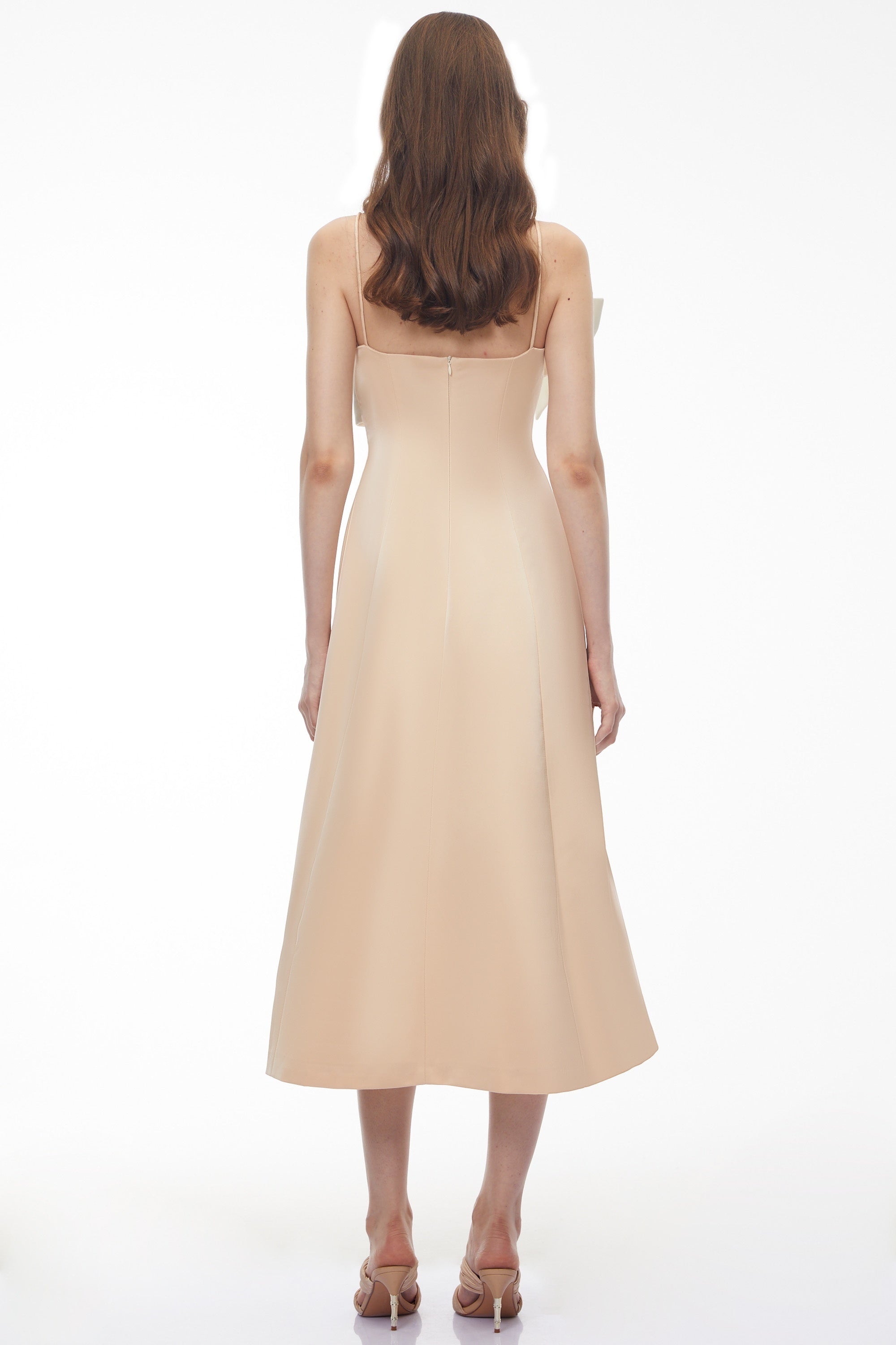 Cream midi dress featuring a white satin sculptural bodice and a slim shoulder strap