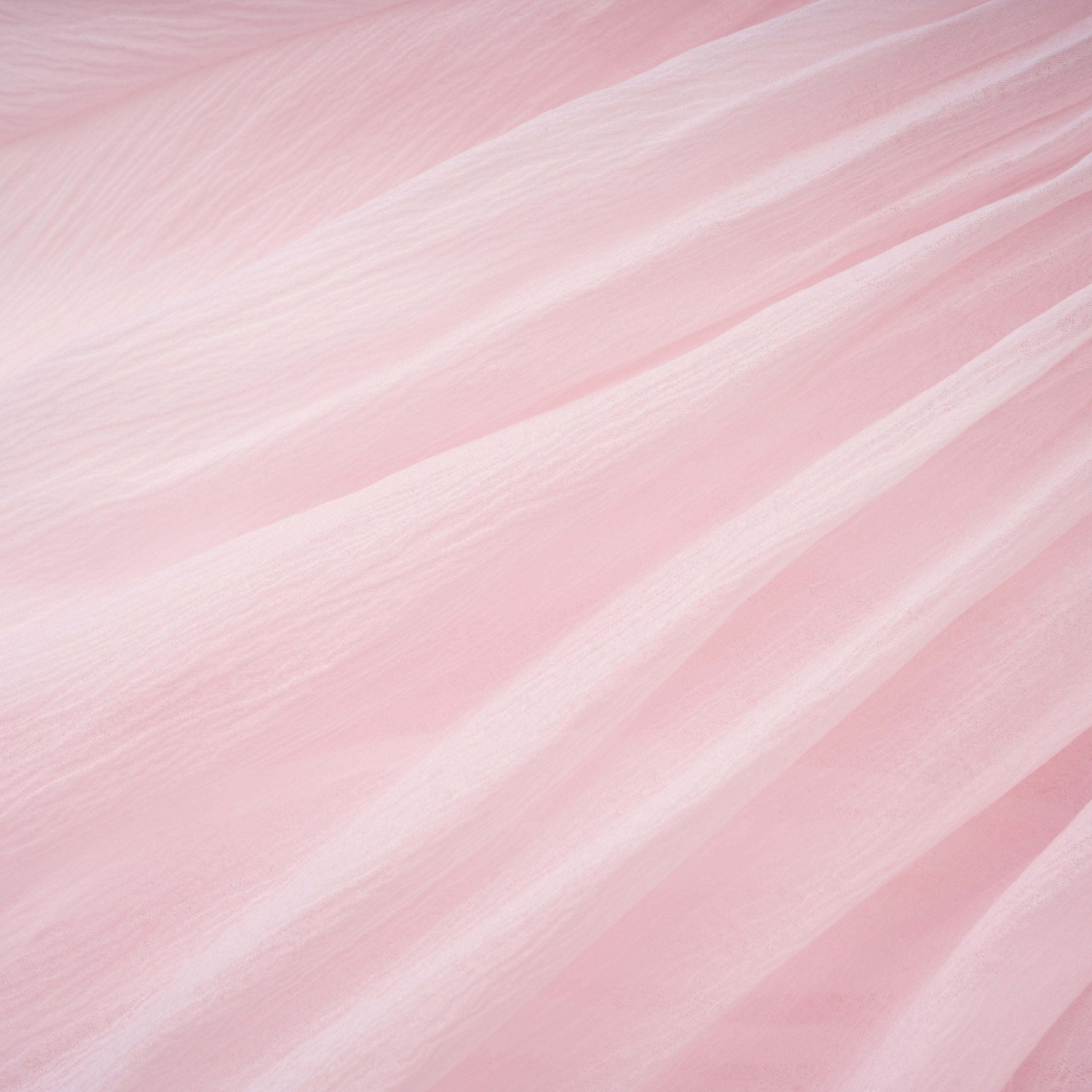 Light pink strapless ruched mini dress featuring a layered ruffle hemline