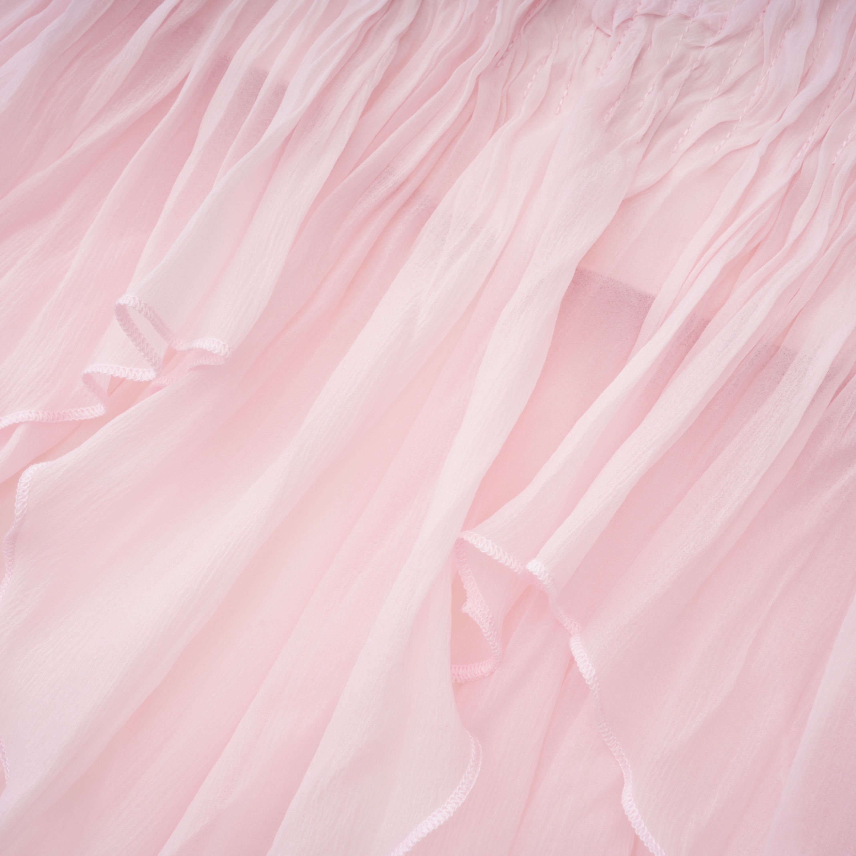 Light pink strapless ruched mini dress featuring a layered ruffle hemline