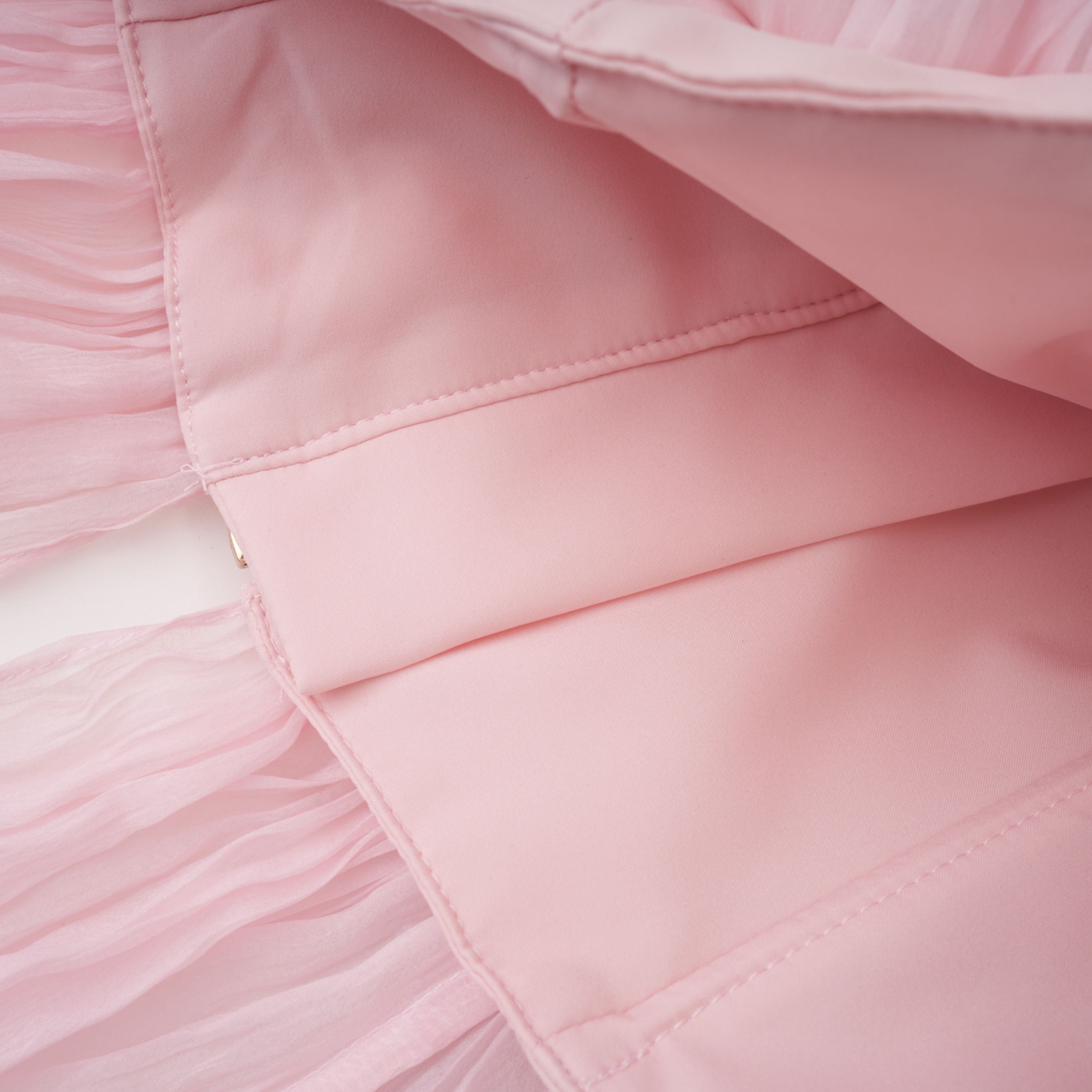 Light pink strapless ruched mini dress featuring a layered ruffle hemline