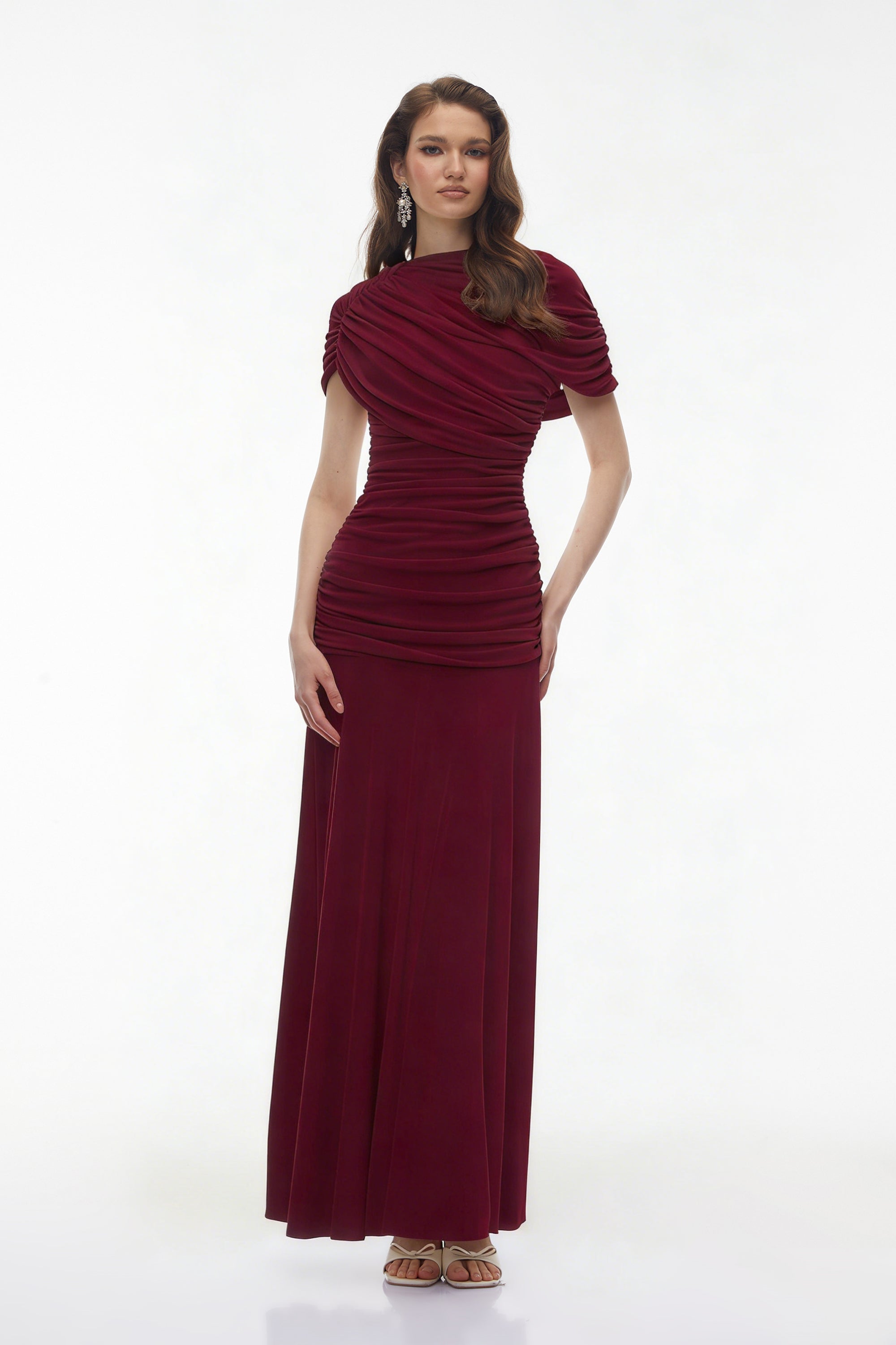 Burgundy maxi dress with an asymmetric draped cowl neckline, a ruched bodice, and a flowing skirt