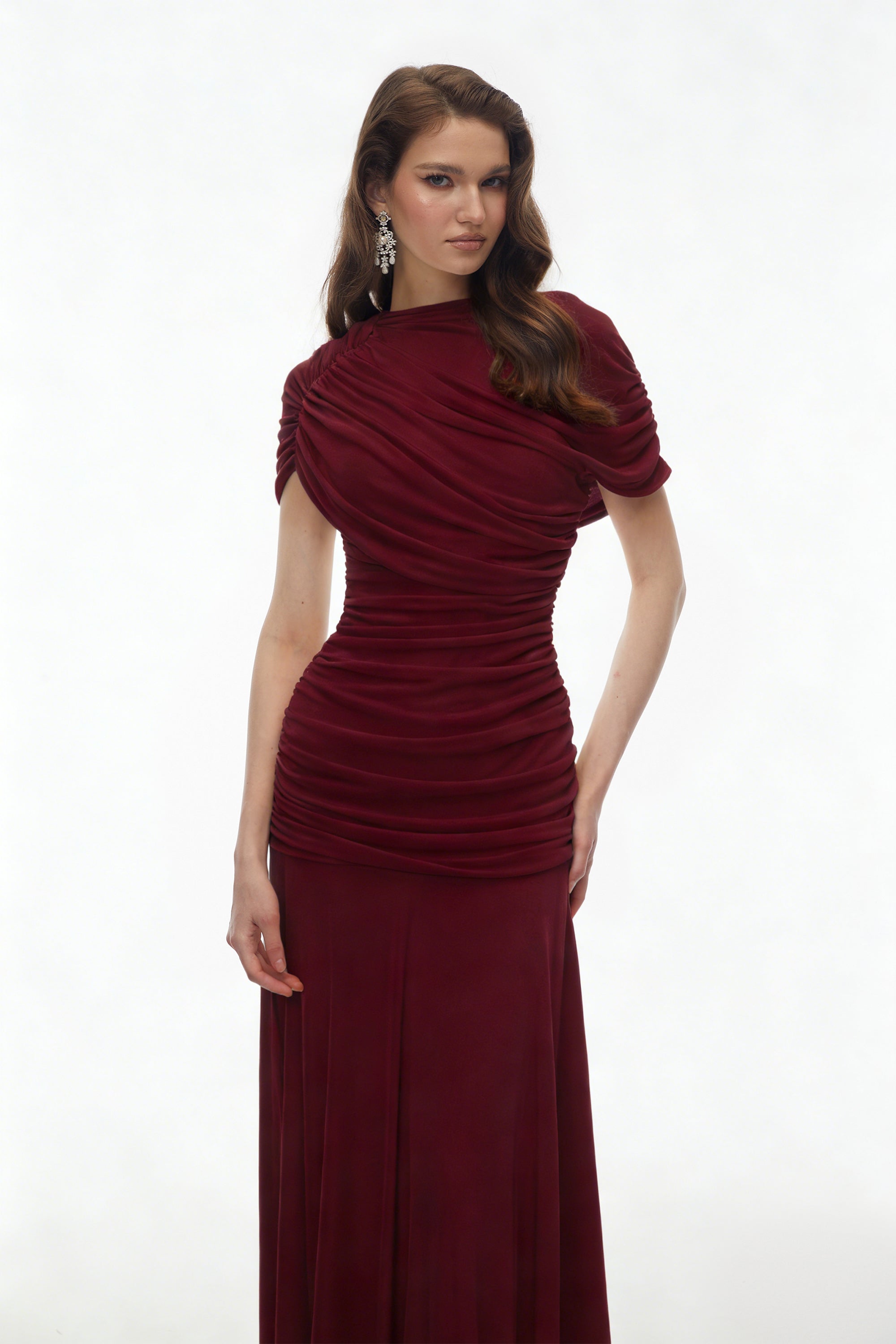 Burgundy maxi dress with an asymmetric draped cowl neckline, a ruched bodice, and a flowing skirt