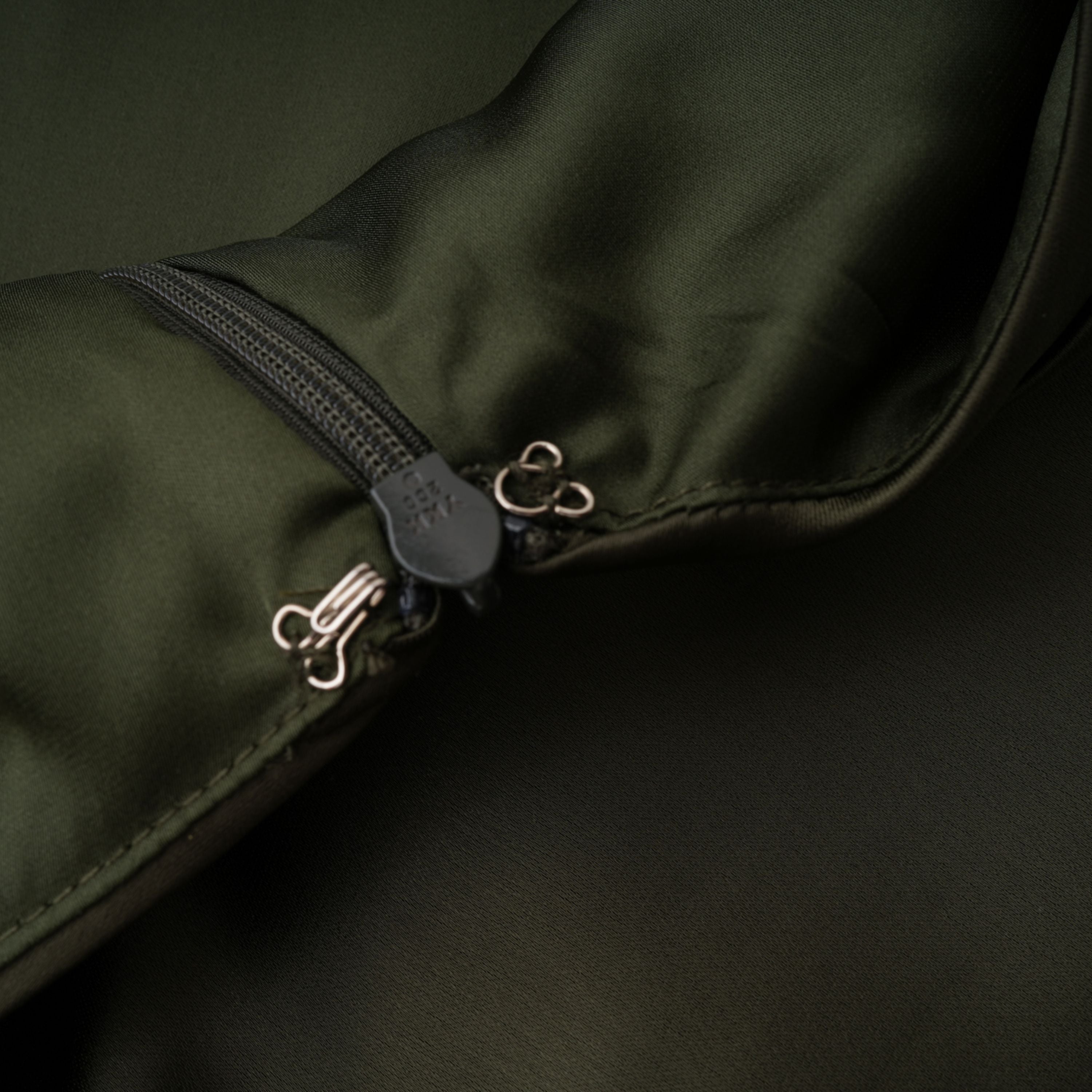 Olive green satin maxi dress with a draped one-shoulder neckline and ruched fitted skirt