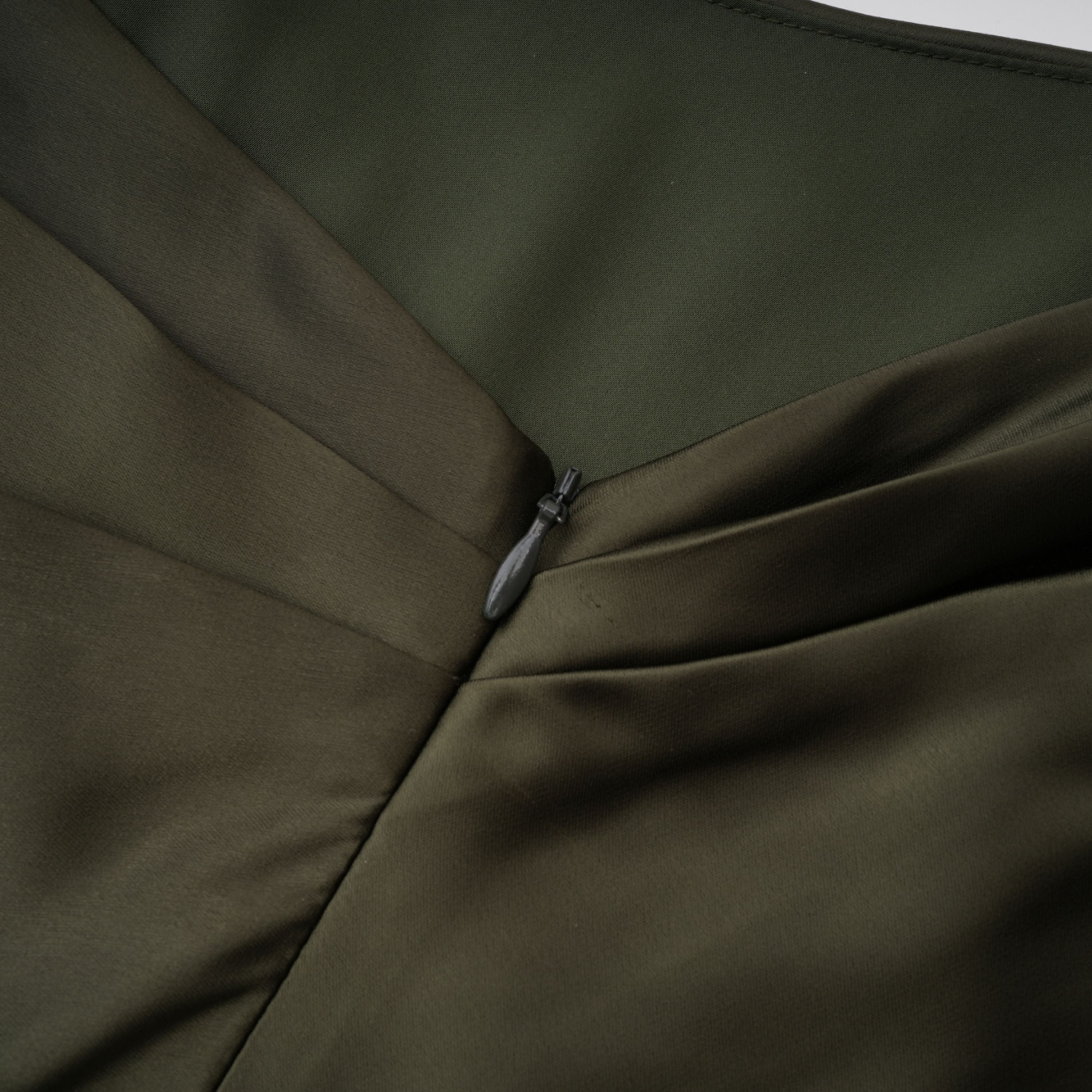 Olive green satin maxi dress with a draped one-shoulder neckline and ruched fitted skirt
