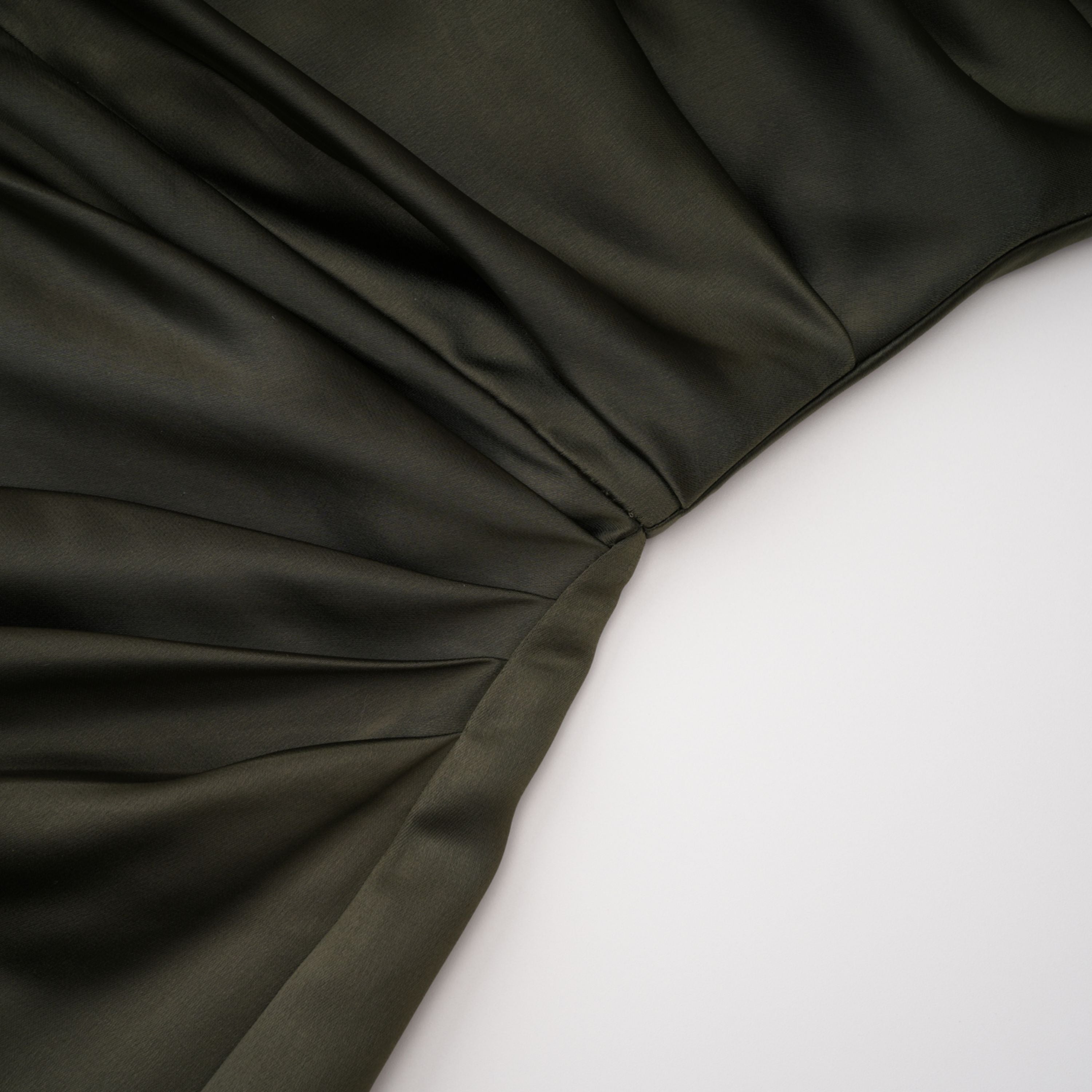 Olive green satin maxi dress with a draped one-shoulder neckline and ruched fitted skirt