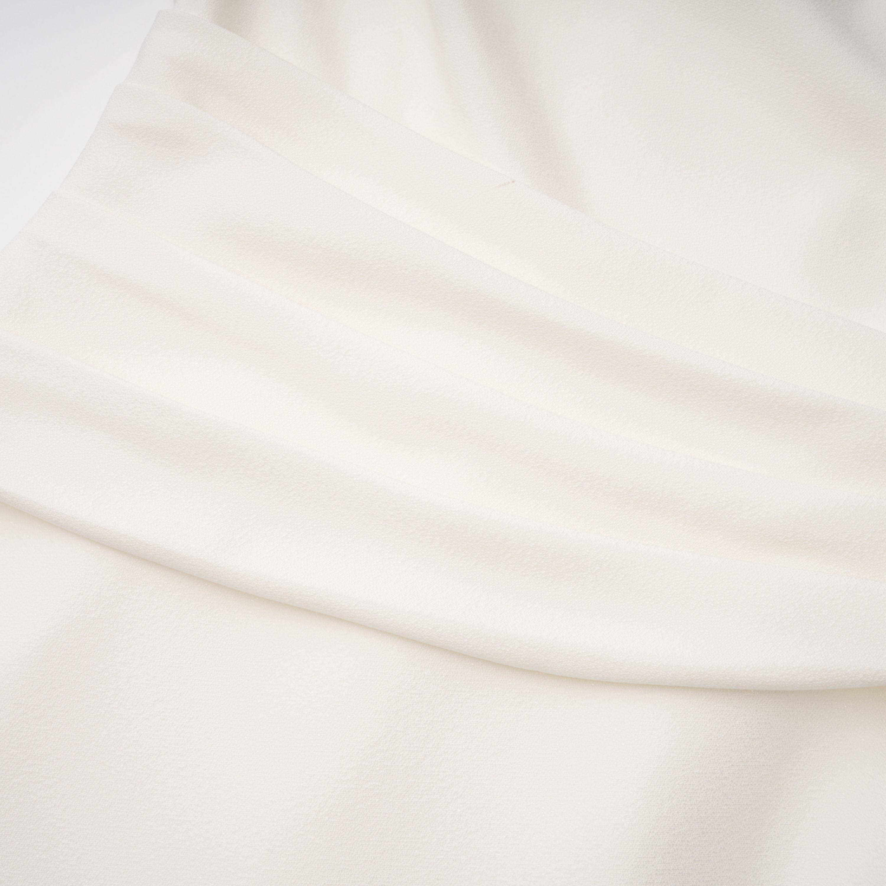 White high-neck halter maxi dress with an open back and asymmetric side drape
