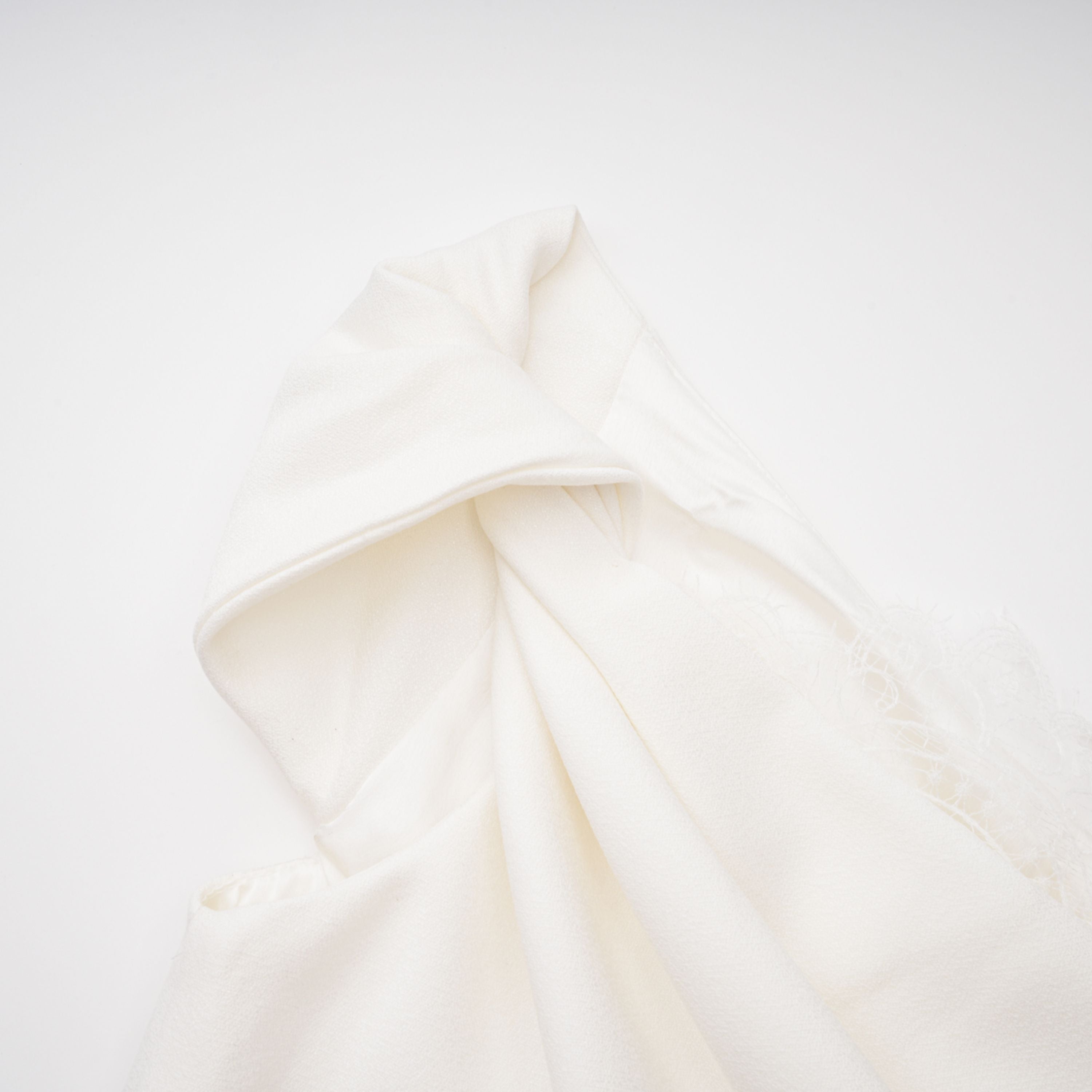 White high-neck halter maxi dress with an open back and asymmetric side drape