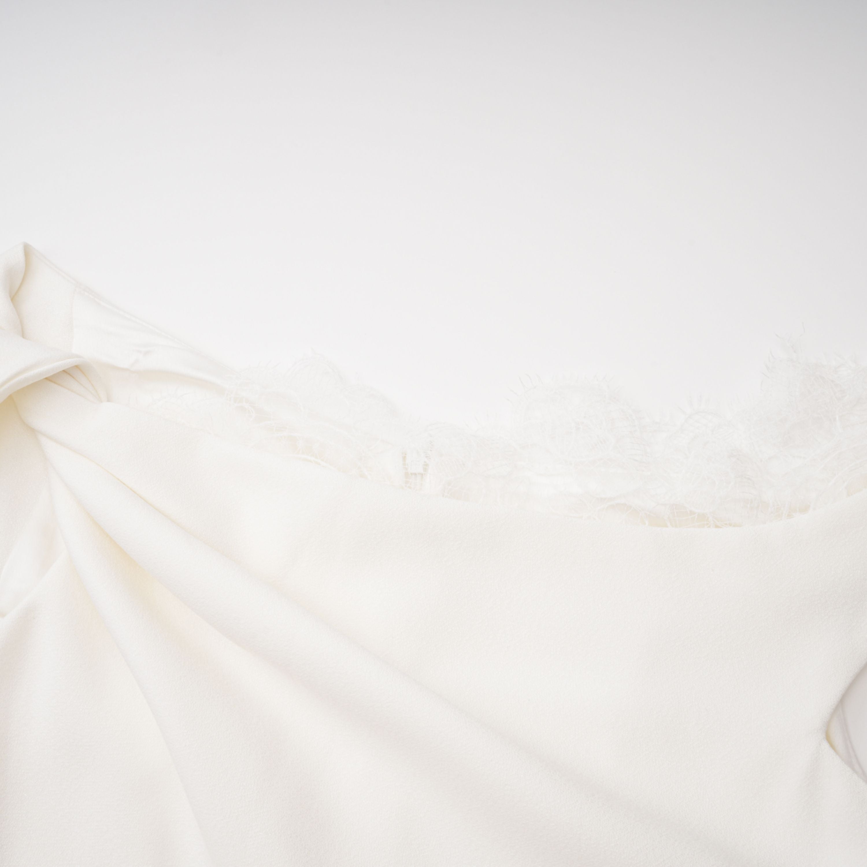 White high-neck halter maxi dress with an open back and asymmetric side drape