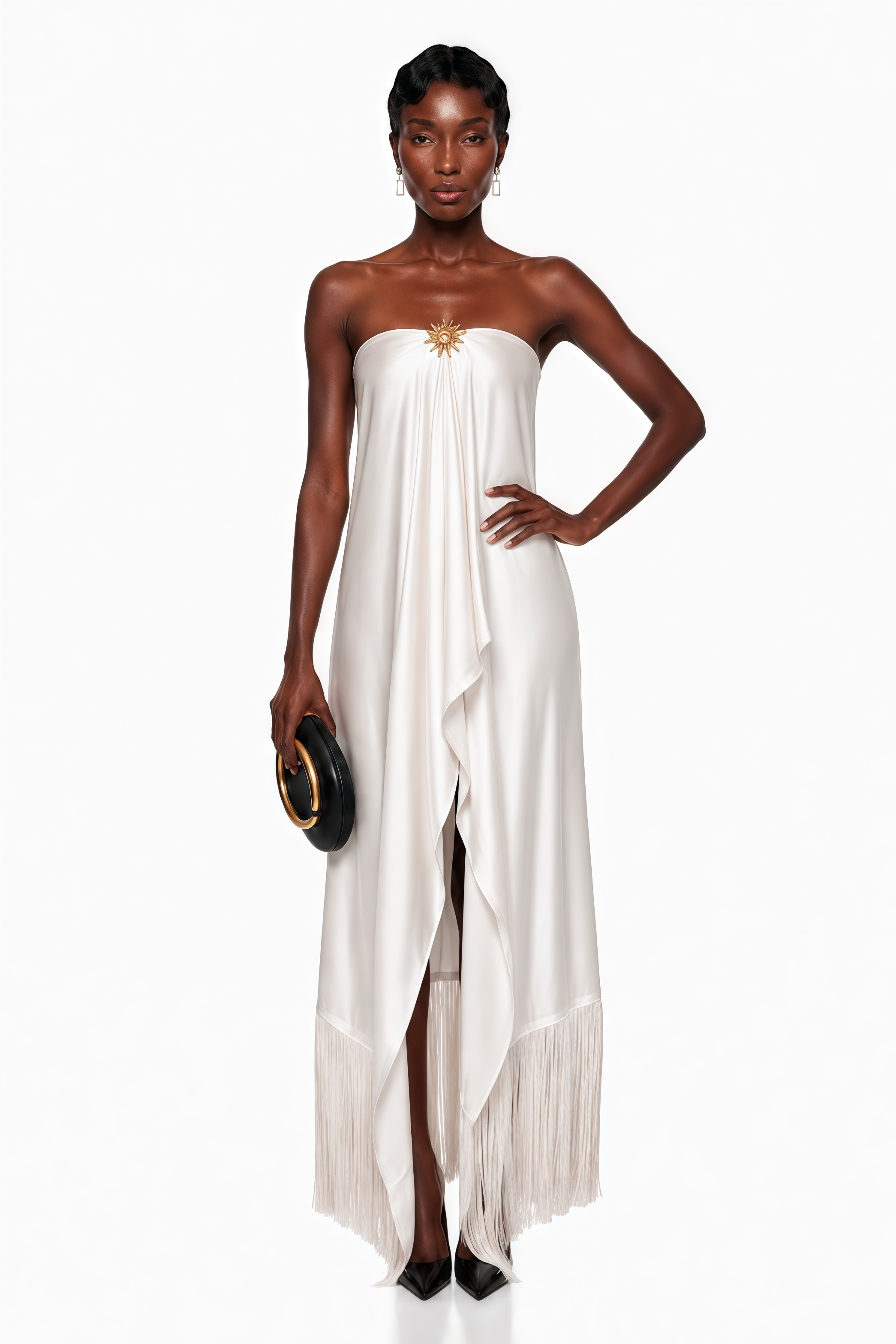 White strapless satin maxi dress with a gold sunburst accent and fringe hem