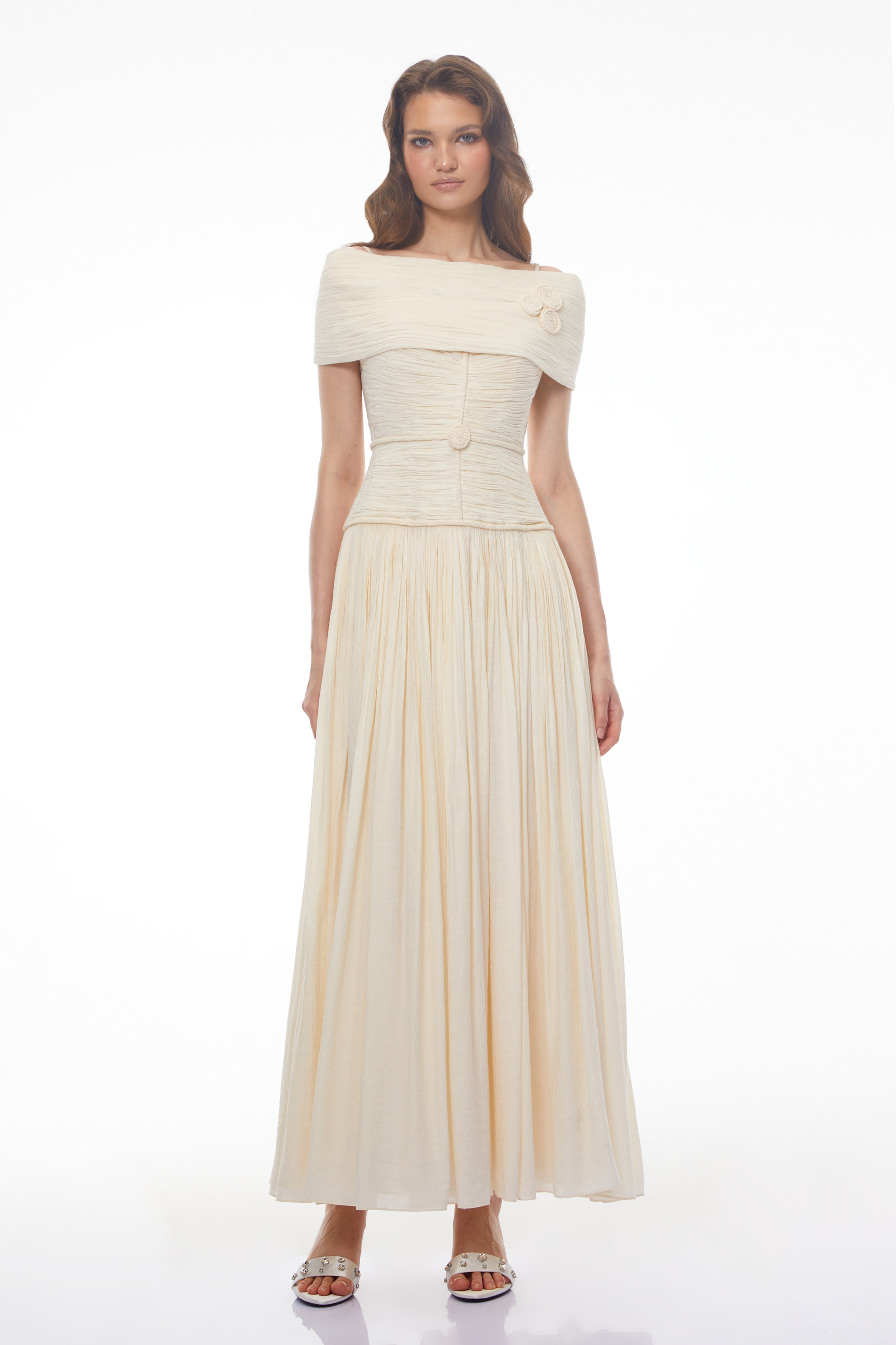 Black strapless maxi dress with a sheer lace corset waist, high leg slit, and a draped skirt