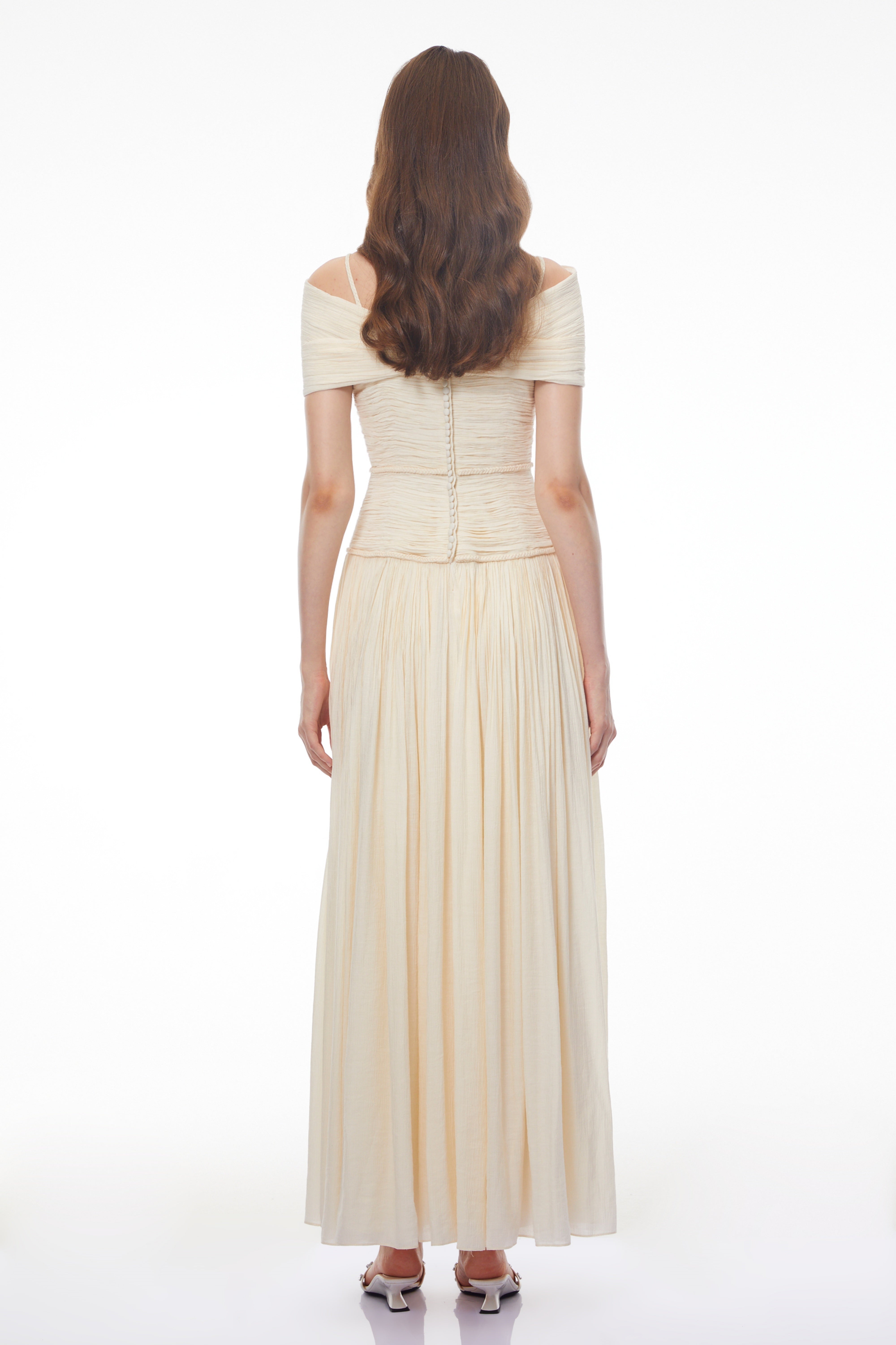 Black strapless maxi dress with a sheer lace corset waist, high leg slit, and a draped skirt