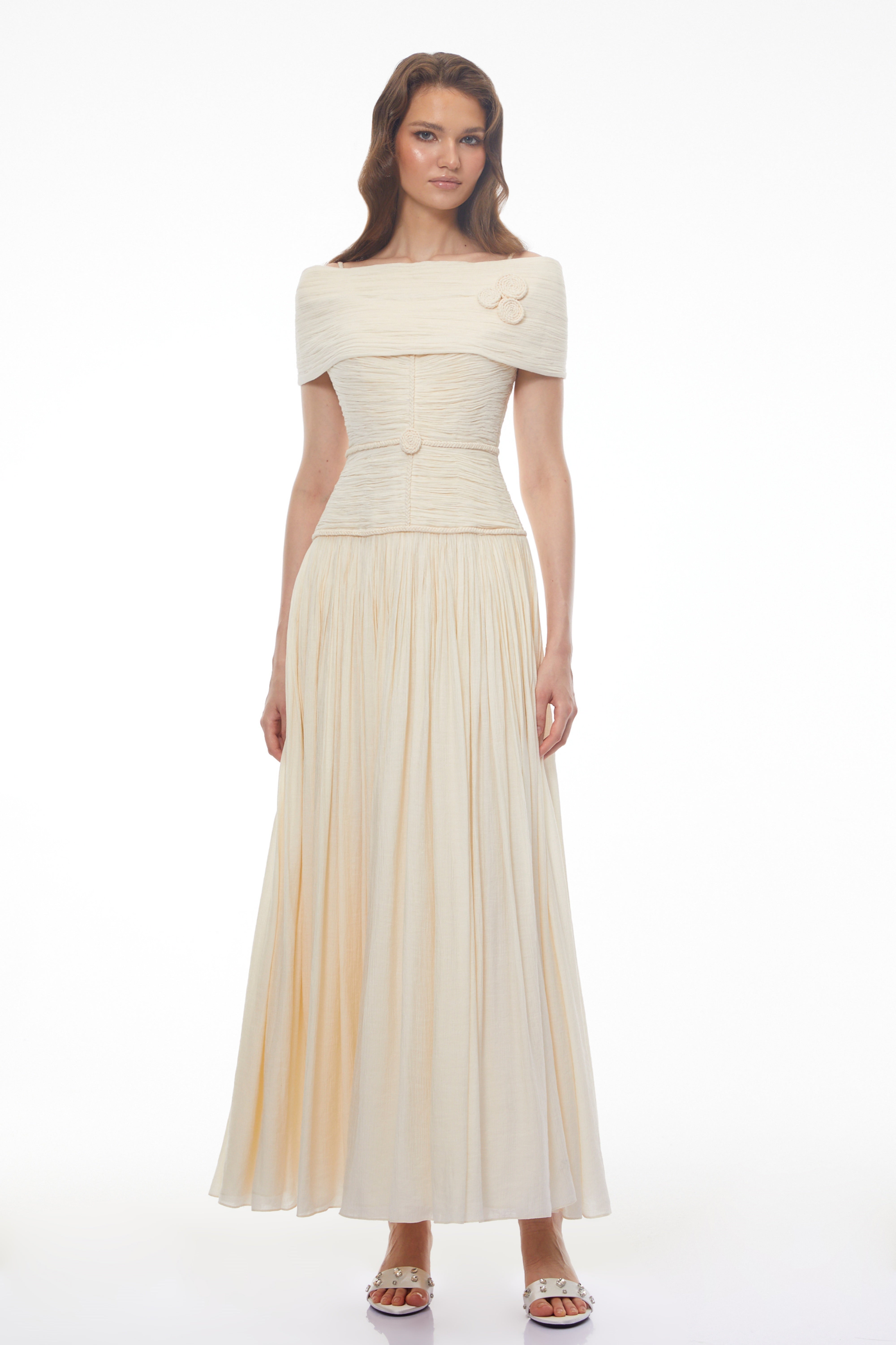 Black strapless maxi dress with a sheer lace corset waist, high leg slit, and a draped skirt