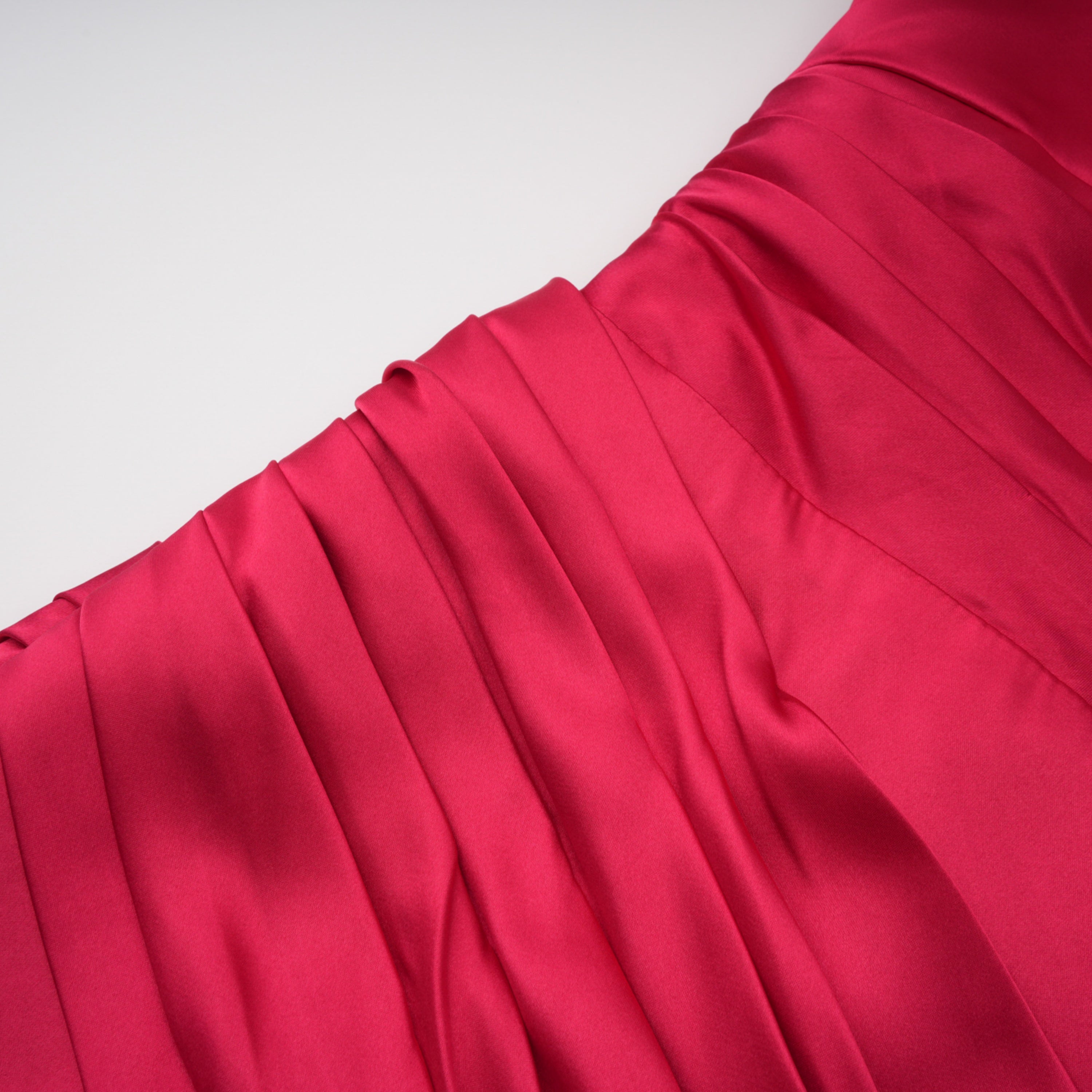 Red one-shoulder satin gown with chest cutout and draped waist